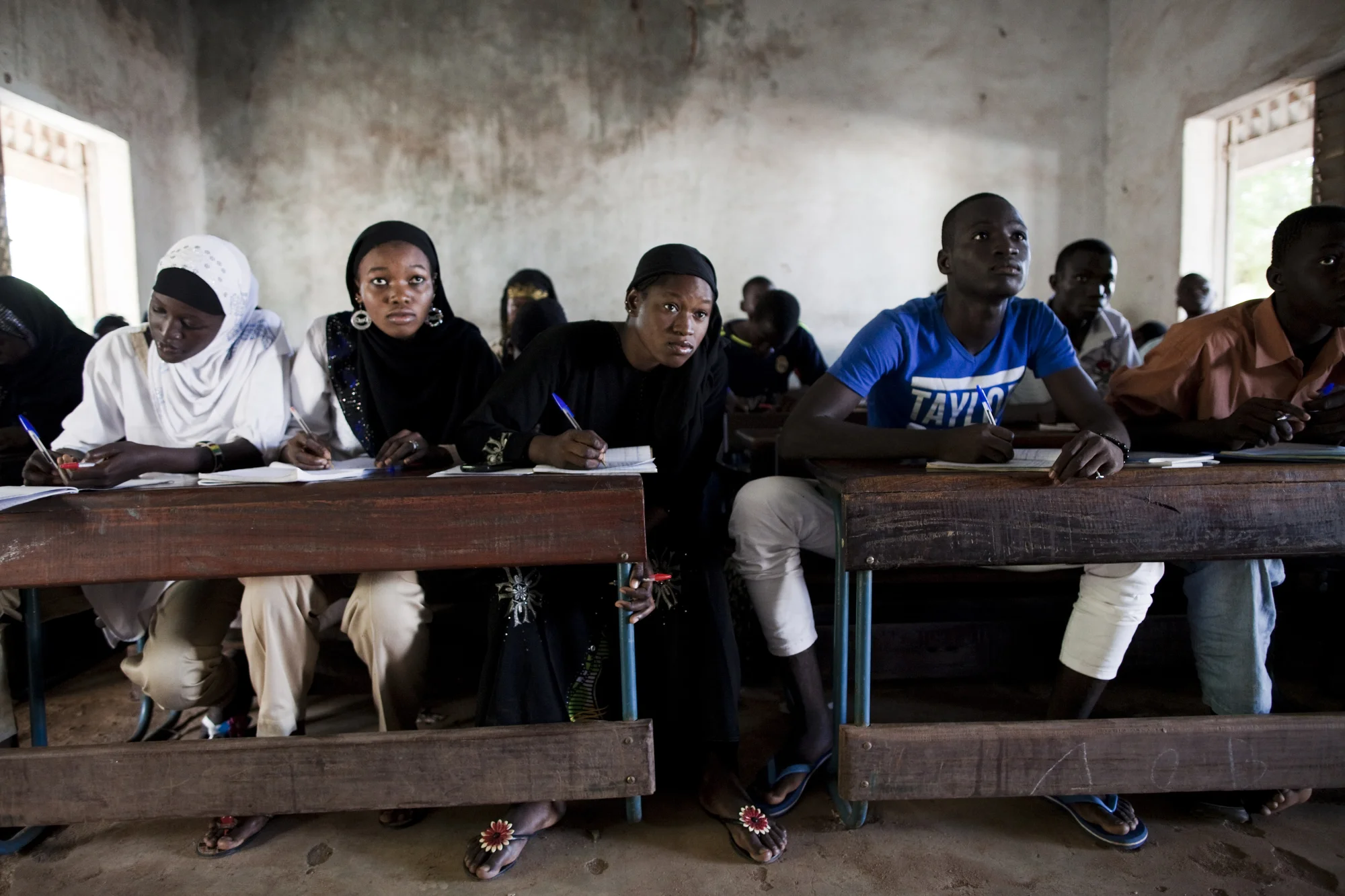 Bamako, Mali. OCTOBER 2013. A co-ed Islamic school in Bamako, Mali.
Summary: Mali, a predominantly Muslim country, has been known for it�s vibrant culture, rich ancient Islamic history, religious tolerance and joyful music and dance. Yet much of this culture was at risk of permanent destruction when militant Islamist rebels took over Northern Mali in 2012. The rebels imposed their own despotic version of religious Islamic law and women bore the brunt of the crackdown. Many women fled, while some remained in the confines of their homes for over a year. In the spring of 2013 the French army entered Mali and defeated the Islamist militias. Photo by Katie Orlinsky.