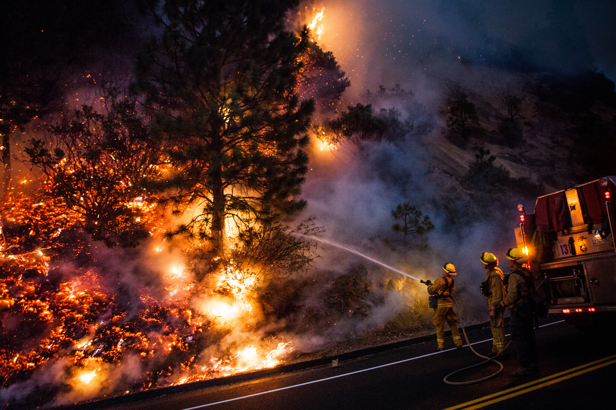  Firefighters work to prevent the Rim Fire from jumping Highway 120 near Buck Meadows, California, August 24, 2013. The Rim Fire burned 257,314 acres and is the third largest wildfire in California history. 