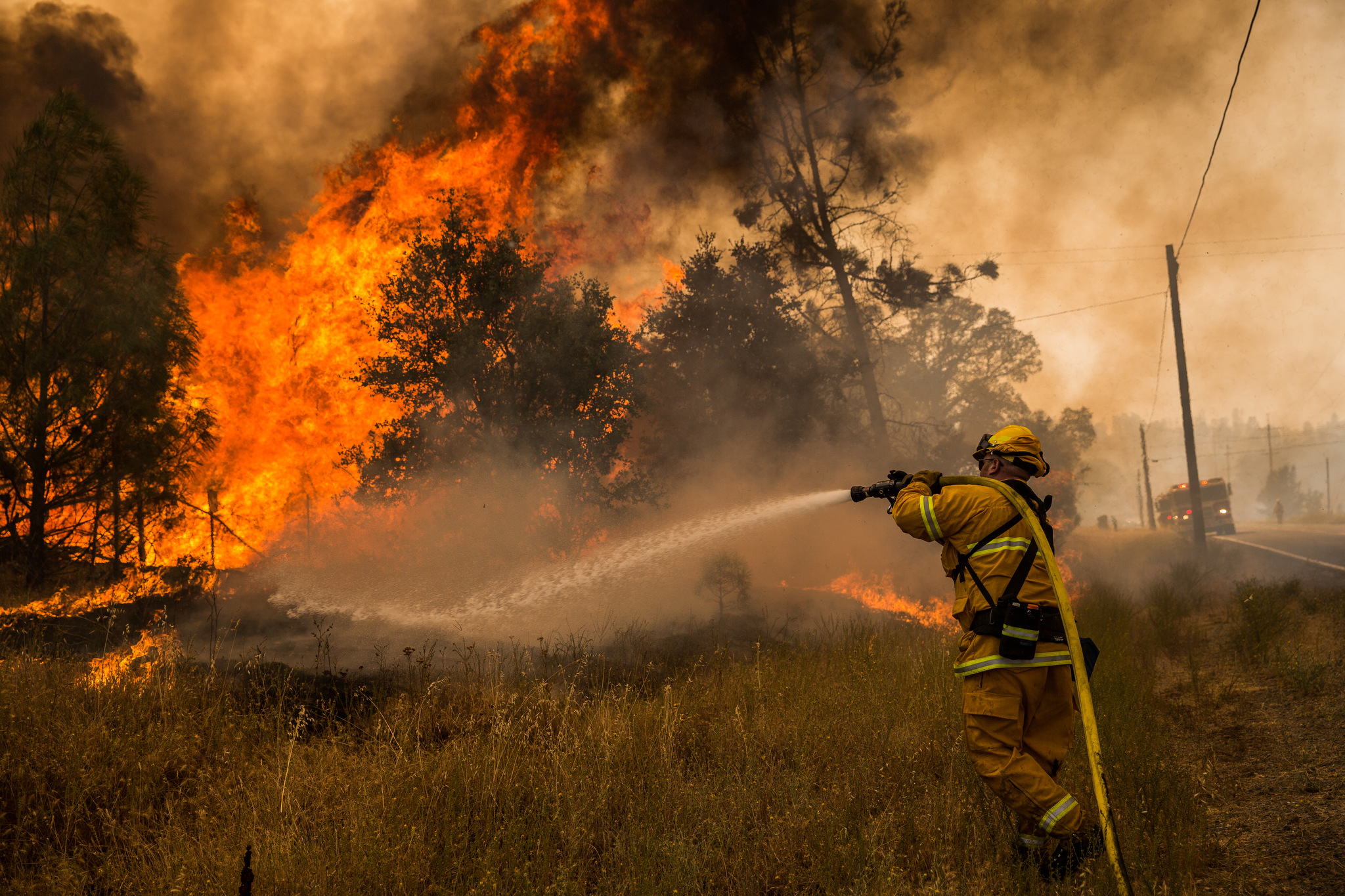  A firefighter battles a spot fire on the Rocky Fire in Lake County, California on July 30, 2015. As of August 5, the fire had consumed 69,600 acres and is one of 23 wildfires burning in California. 