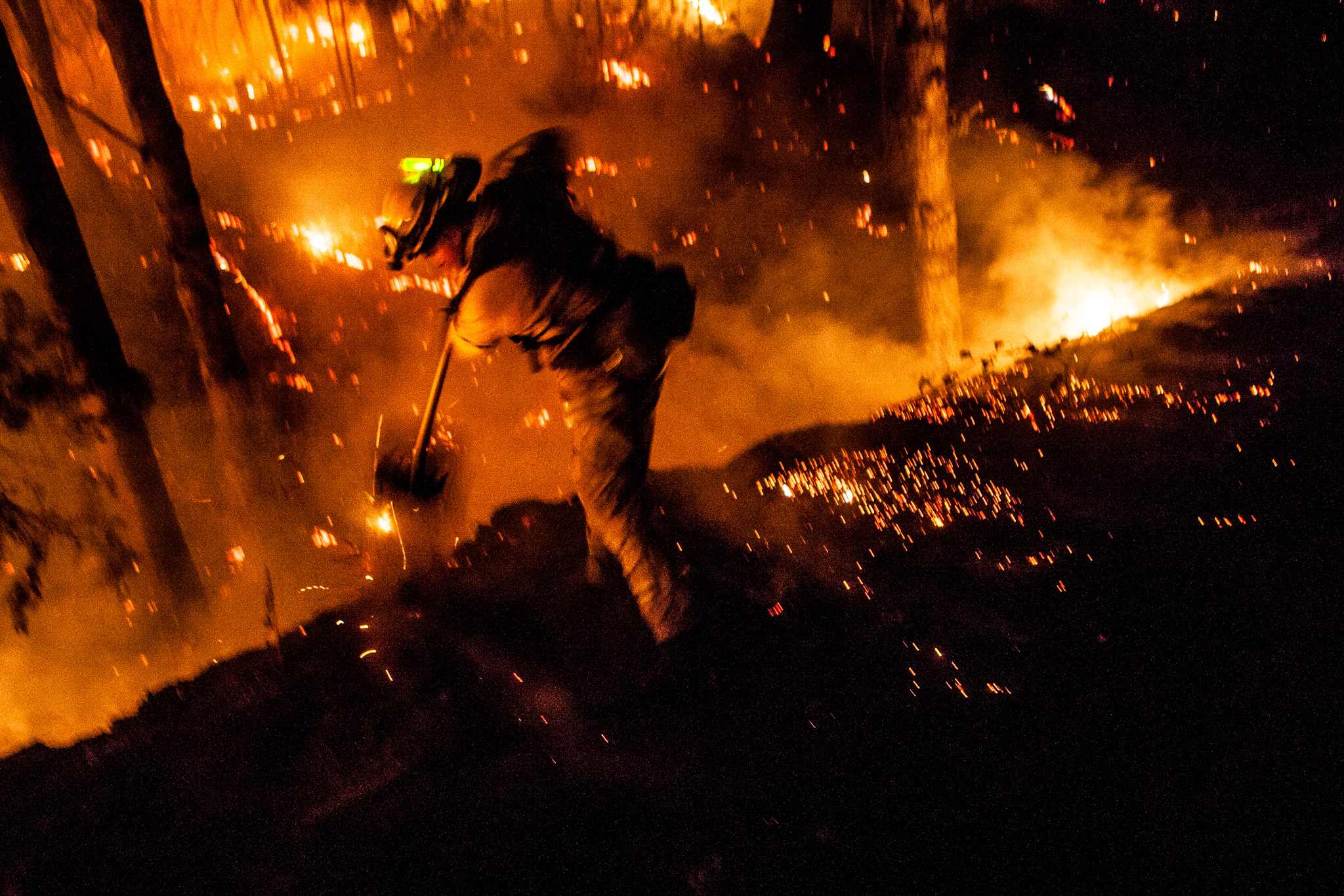  Firefighter Dave Beck rakes embers away from a road on the Rim Fire near Buck Meadows, California, August 22, 2013. The fire burned 257,314 acres in and around Yosemite National Park, and is the biggest wildfire on record in the Sierra Nevada. 