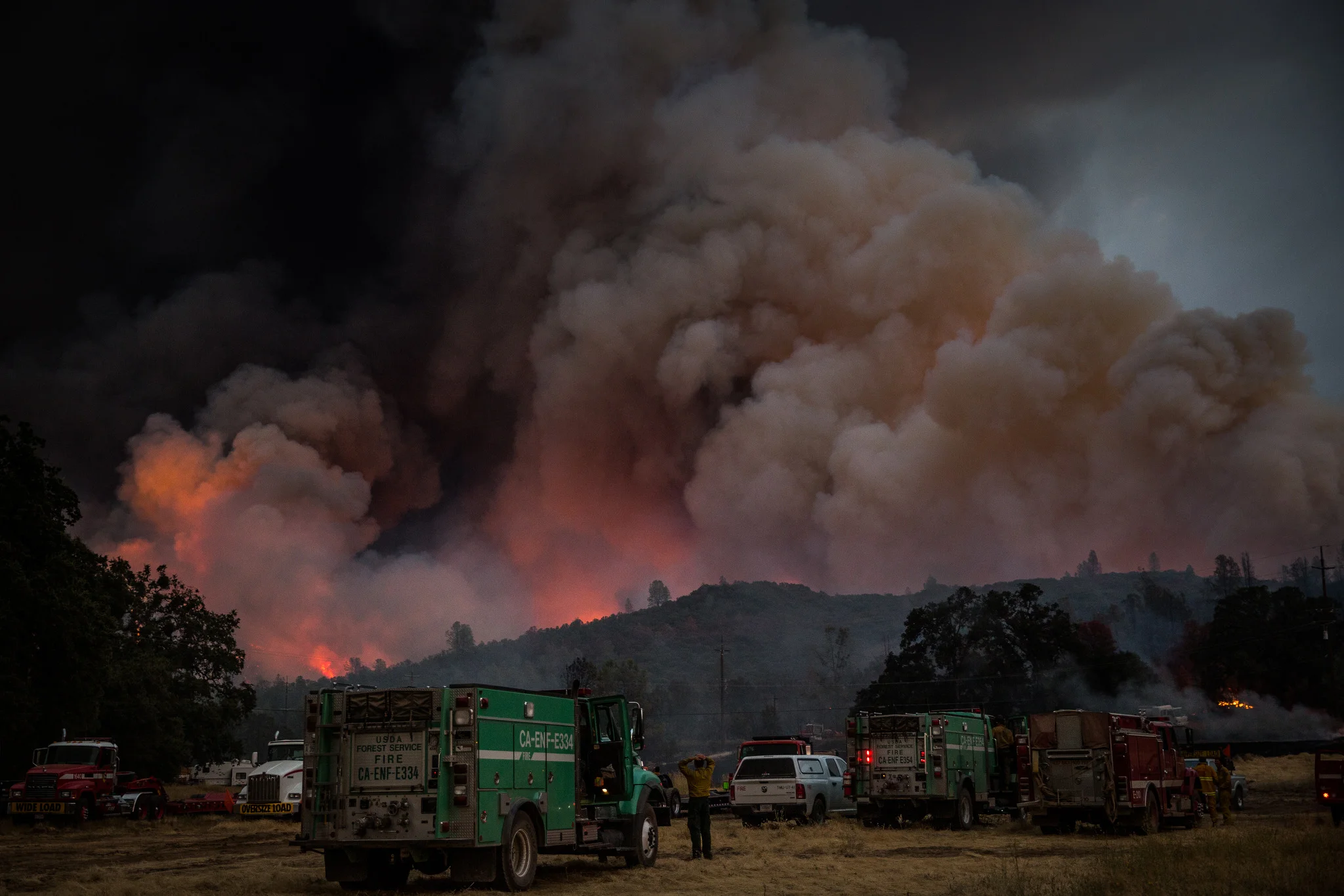 Firefighters watch the Rocky Fire advance in Lake County, California on July 30, 2015. As of August 5, the fire had consumed 69,600 acres and is one of 23 wildfires burning in California.