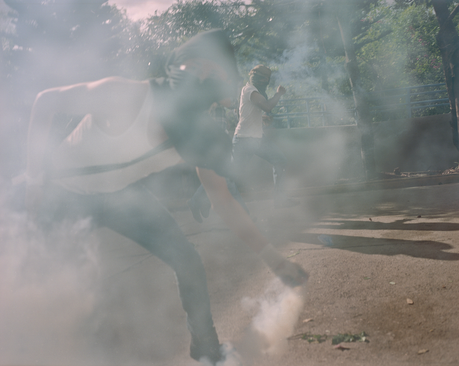 University students throw teargas bombs back at police during an anti fraud protest in Tegucigalpa. 