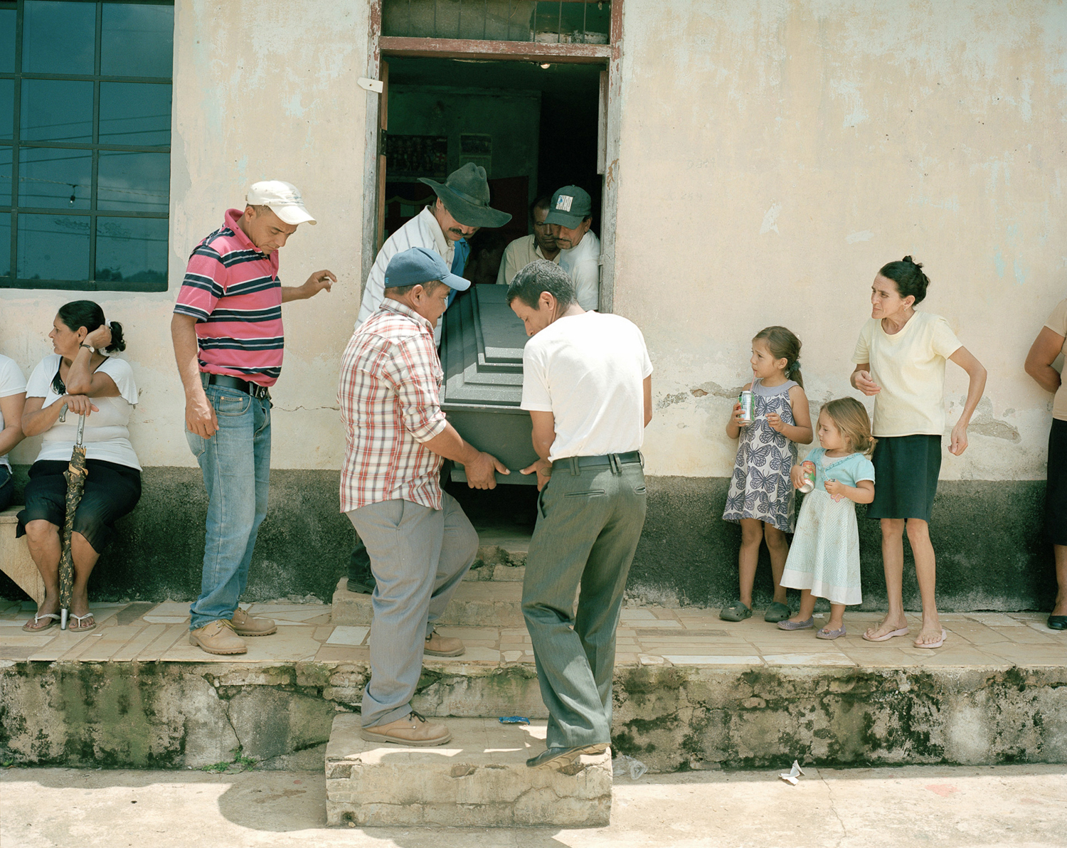  Men carry out the casket of an assassinated community organizer. 