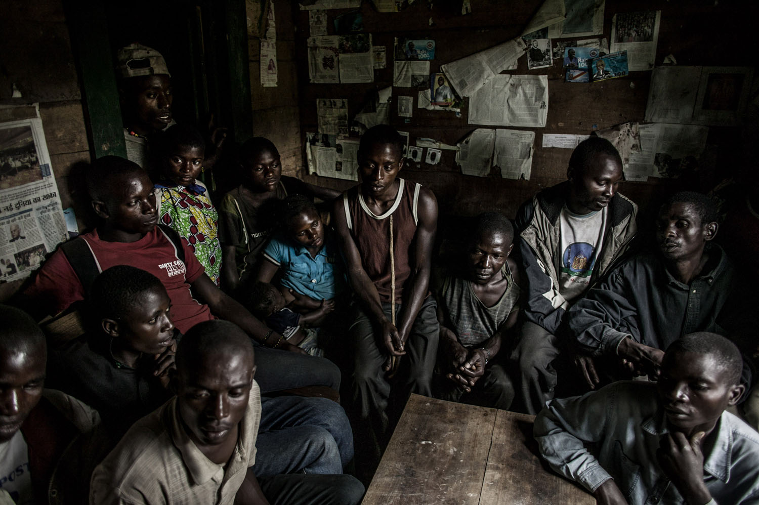 The men of the Kanyabugoyi family gather inside their family home in the village of Rugare, which was recently wrest from M-23 rebels by the Congolese army. The family fled their home in August after being continually harassed by M-23 rebels. When t