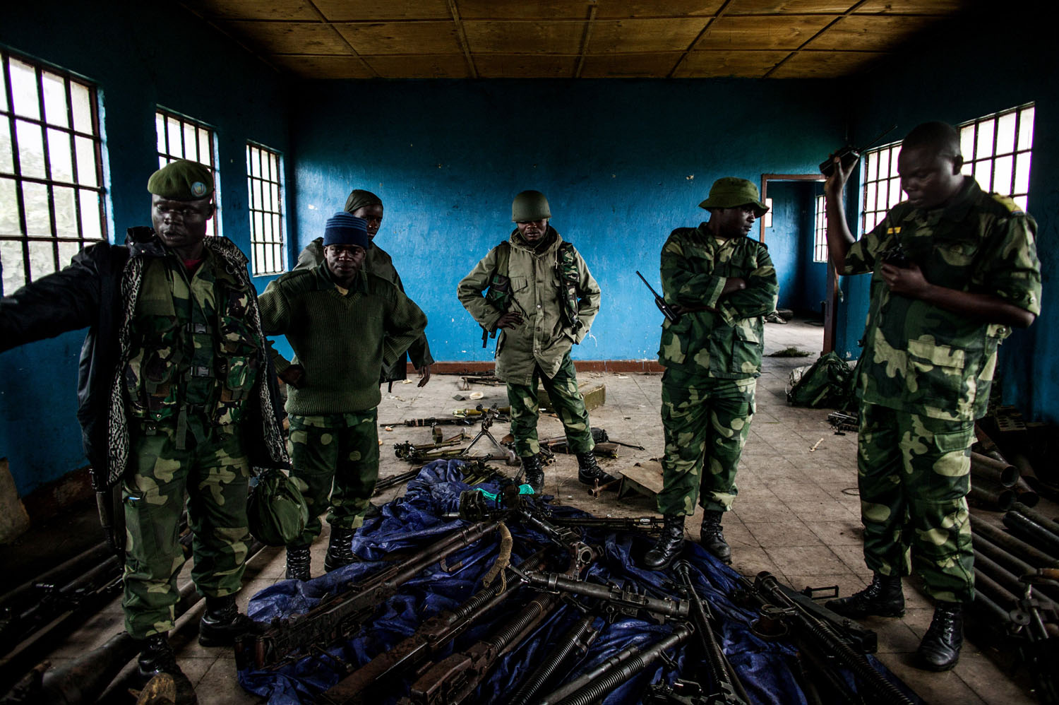  Congolese soldiers inspect munitions abandoned by M23 rebels at a former M-23 military base in Rumangabo, north of Goma. 