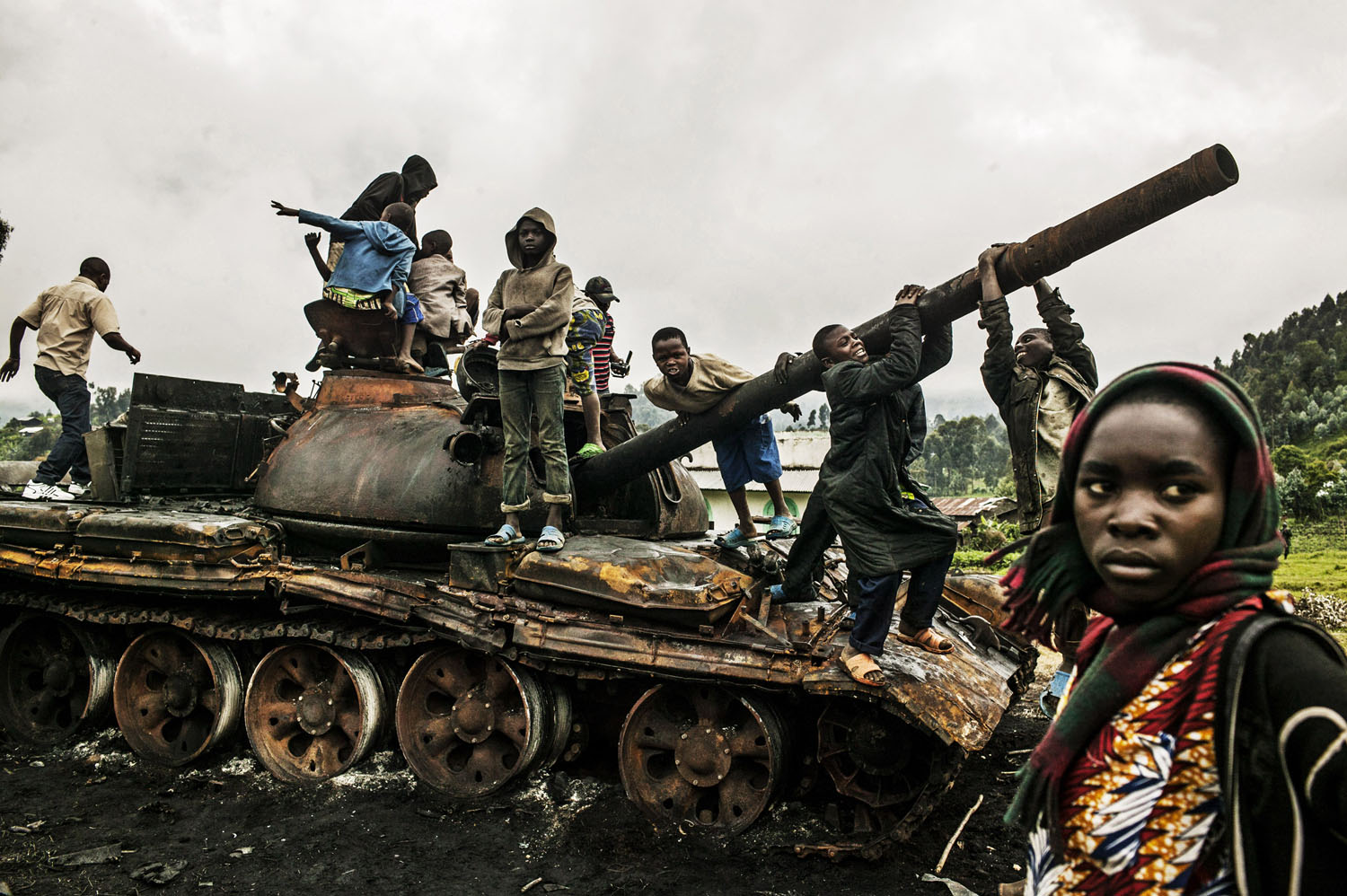  Congolese children play on a destroyed M-23 tank near Kibumba, north of Goma on Tuesday. Kibumba was the site of heavy fighting between the Congolese army and M-23 rebels on Sunday. 
