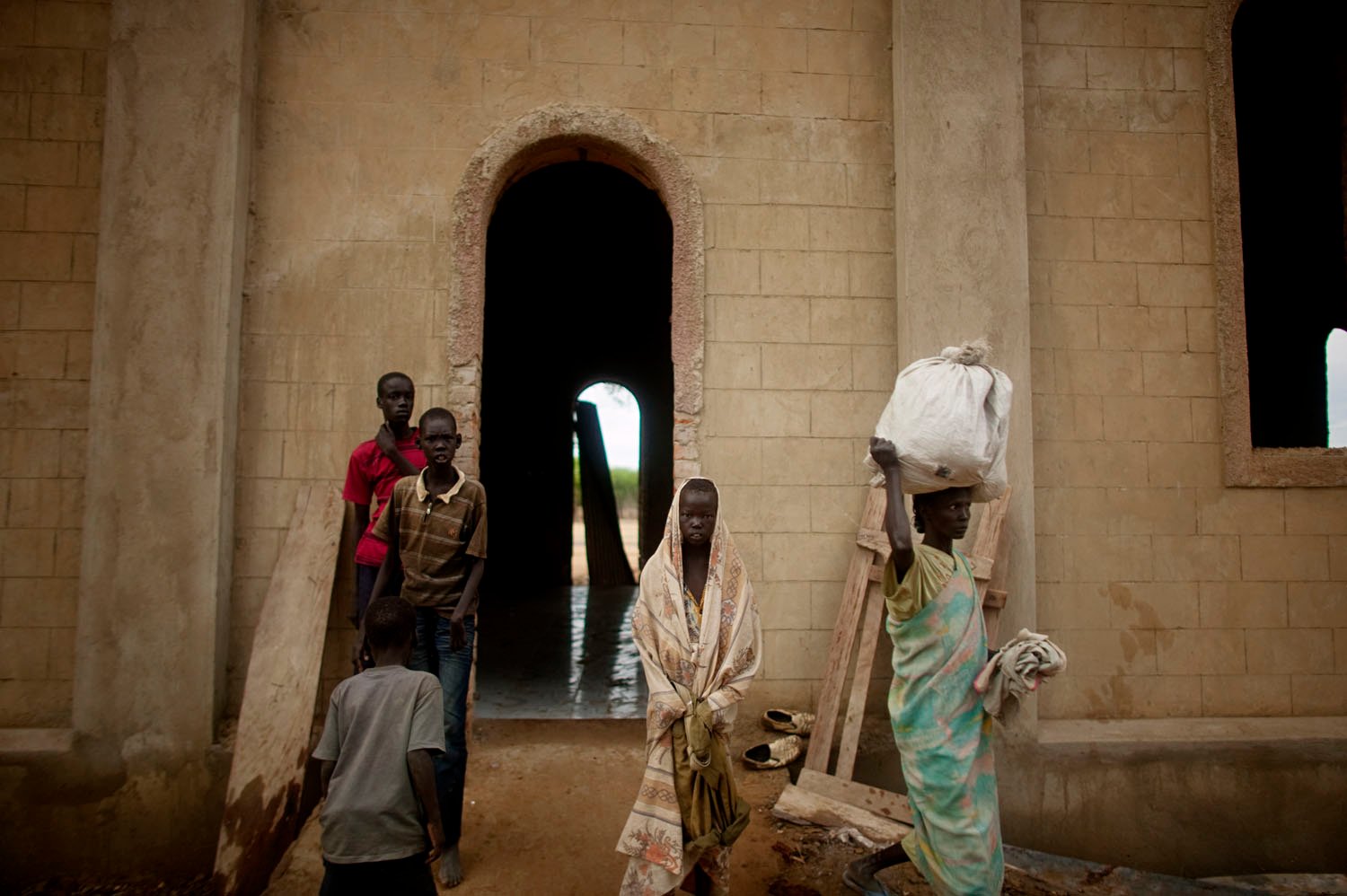  Internally displaced southern Sudanese outside a church that is serving as a makeshift camp in the village of Mayen Abun, southern Sudan on Thursday May 26, 2011. Tens of thousands of southern Sudanese fled heavy fighting in the hotly contested bord