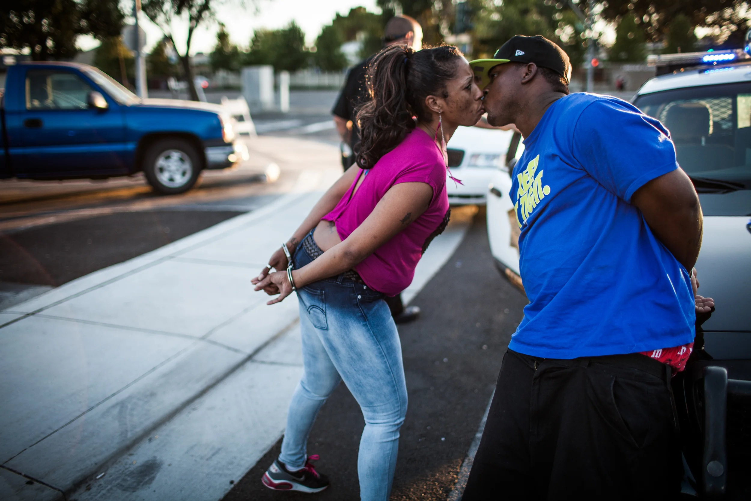 A couple kisses as they're separated and arrested after a handgun and drugs are found in their car during a traffic stop by the Community Response Team in Stockton, California September 18, 2013 which targets violent gangs. The officer found a handgun and heroin in the car. Facing stark and rising homicide rates, the California cities Oakland and Stockton are taking a second chance at a novel method of disrupting street gangs, called Ceasefire, in which the police use social-analytics software to map out connections between a cityís most violent gang members, using the data to make targeted and coordinated arrests.