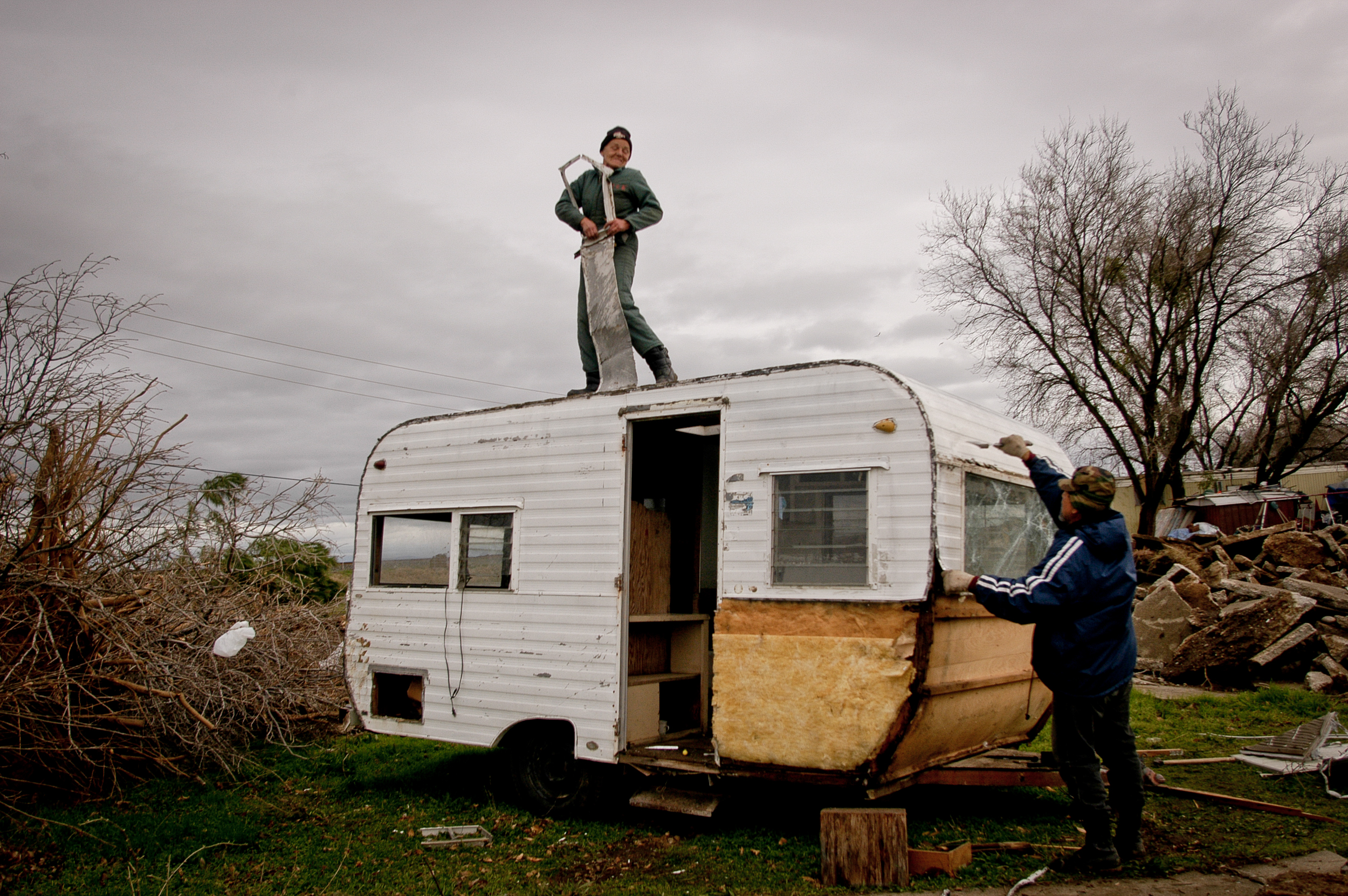  After the county shuts down the Andina Village trailer park in Olivehurst, California, resident Linda Zachary strips metal off an abandoned trailer to sell for scrap. 