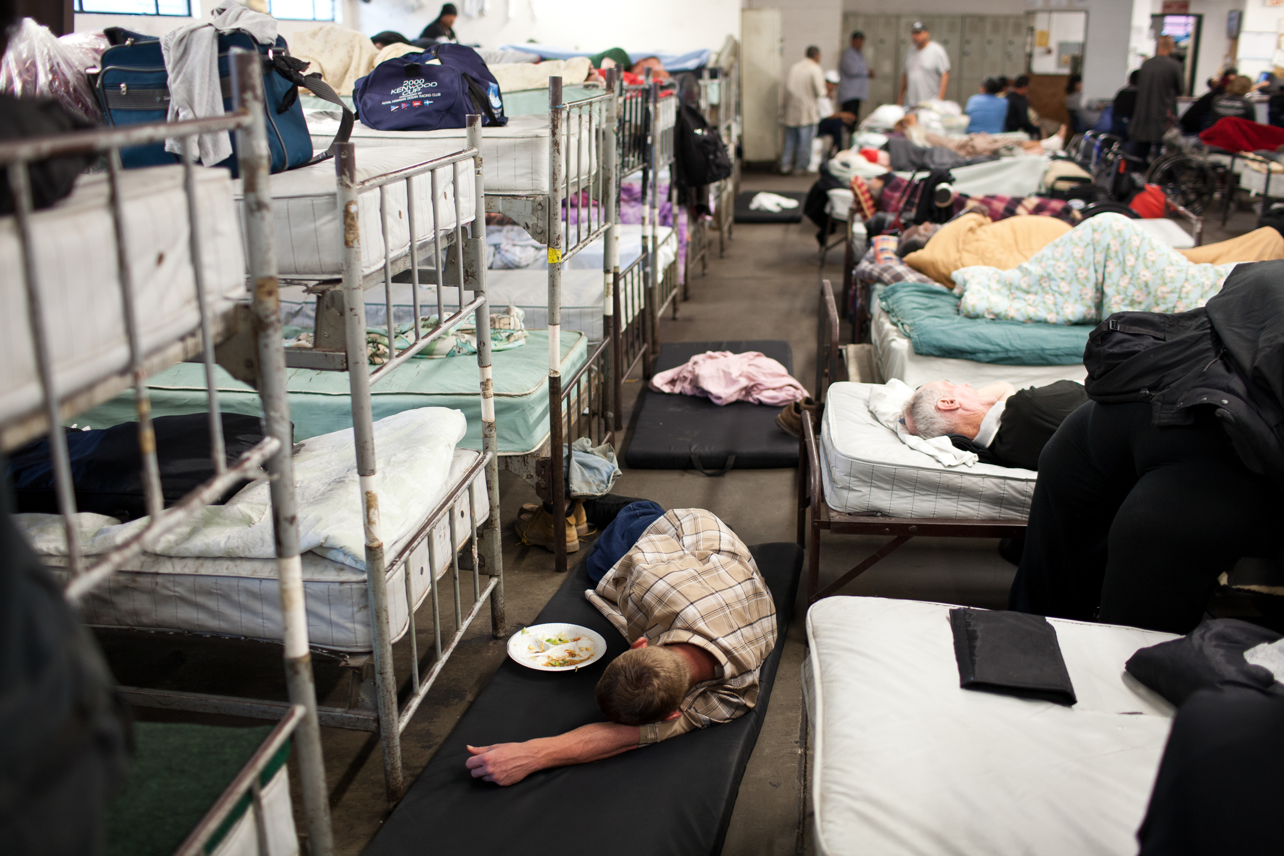  An overflow crowd of homeless men take up every cot and use mats on the floor to sleep at Stockton's Shelter for the Homeless, July 18, 2012. With some of the highest rates of unemployment and home foreclosures in the country, Stockton, the largest 