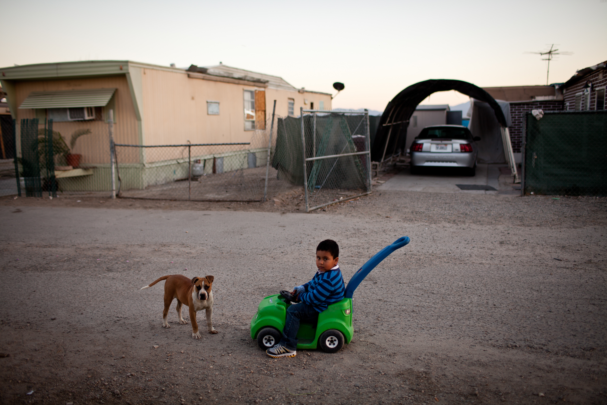  A three-year-old boy plays in the Rancho Garcia trailer park in Thermal, California. 