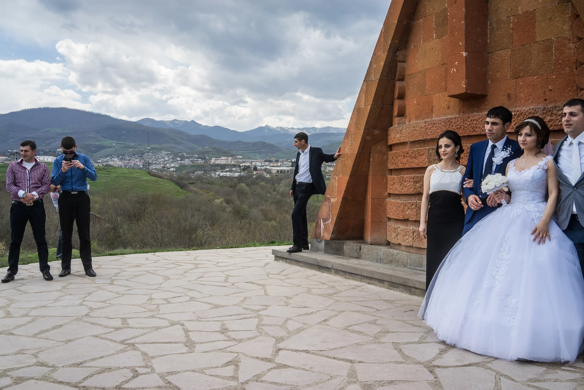 Groom Davit Simonyan, 24, and bride Shogher Hovsepyan, 25, take photos with family and friends at the Tatik Papik monument, a popular symbol of Nagorno-Karabakh, on April 18, 2015 in Stepanakert, Nagorno-Karabakh. Since signing a ceasefire in a war with Azerbaijan in 1994, Nagorno-Karabakh, officially part of Azerbaijan, has functioned as a self-declared independent republic and de facto part of Armenia, with hostilities along the line of contact between Nagorno-Karabakh and Azerbaijan occasionally flaring up and causing casualties.