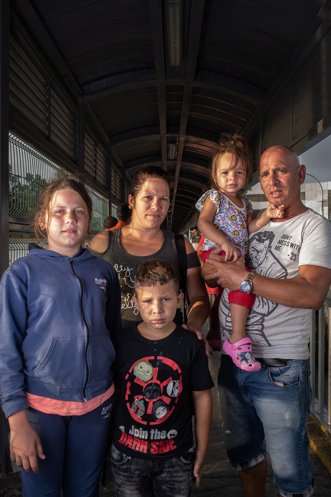  Portrait of Lorena (12), Laurel (31), Raydel (7), Yarena (2), and Raydel (45), from Cuba at Laredo / Nuevo Laredo International Bridge. They decided to leave their homecountry due to the economic and social crisis. They approached the border to ask 