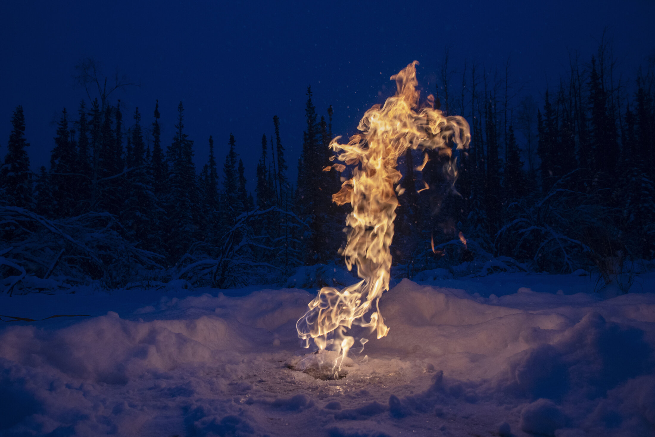  Thawing permafrost beneath the earth's surface releases methane gas into Arctic lakes causing gas bubbles to form in the frozen water. If the gas is released, just a small flame can create a huge (brief) fire on top of the lake's surface, as demonst