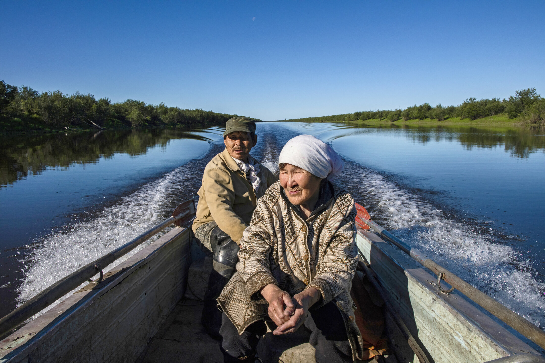  Nikolai and Ivana check their fish line near their home outside of Chersky, Siberia. Families in this region depend on fishing and hunting as dietary staples, and struggle to keep their fish and meat fresh with their ice cellars, or freezers, that a