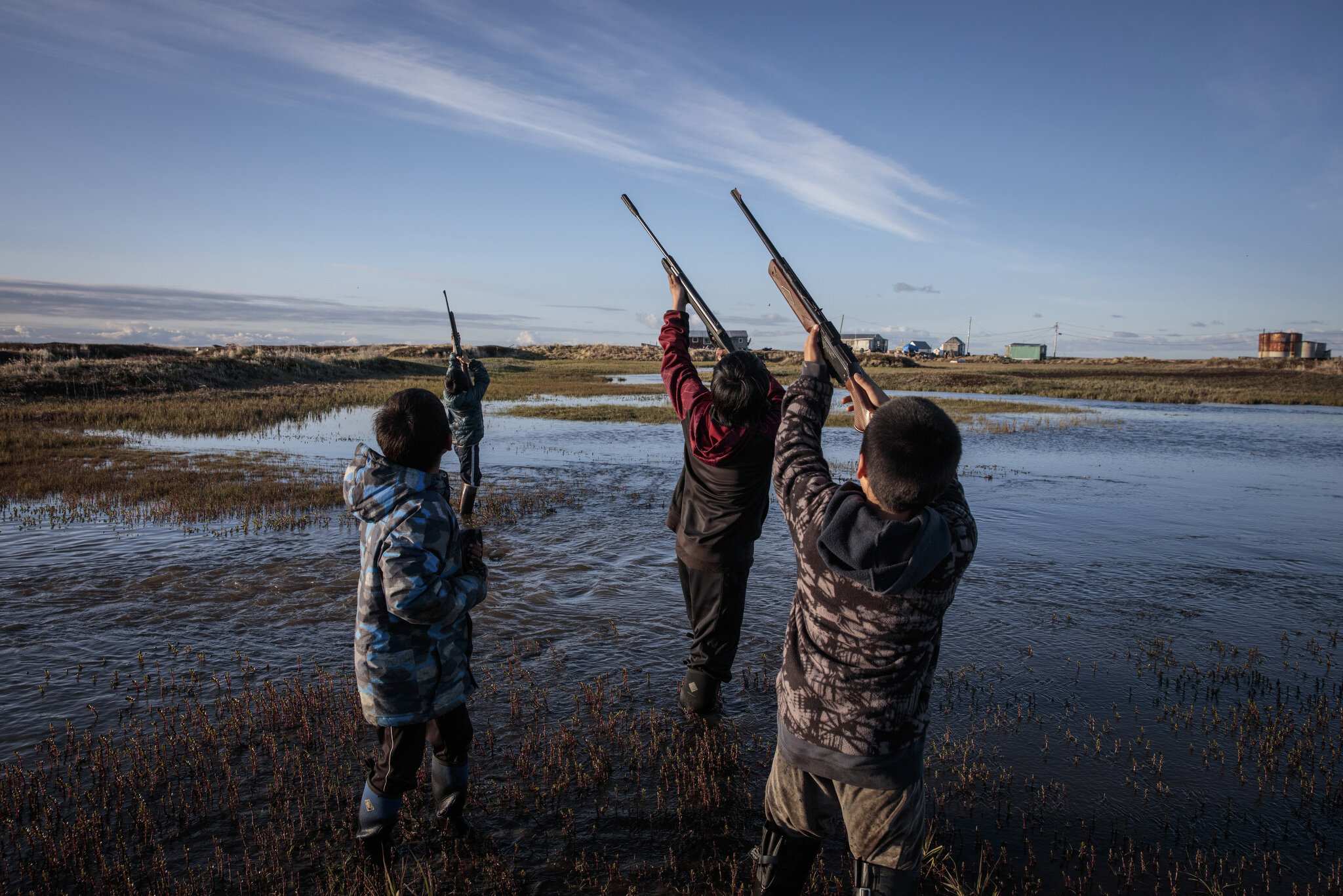 Boys on a summer bird hunt in the flooding village of Newtok, Alaska. May 27th, 2019. The Yupik village of Newtok, Alaska, population 380, is sinking as the permafrost beneath it thaws. Erosion has already wiped out nearly a mile of Newtok’s land, a