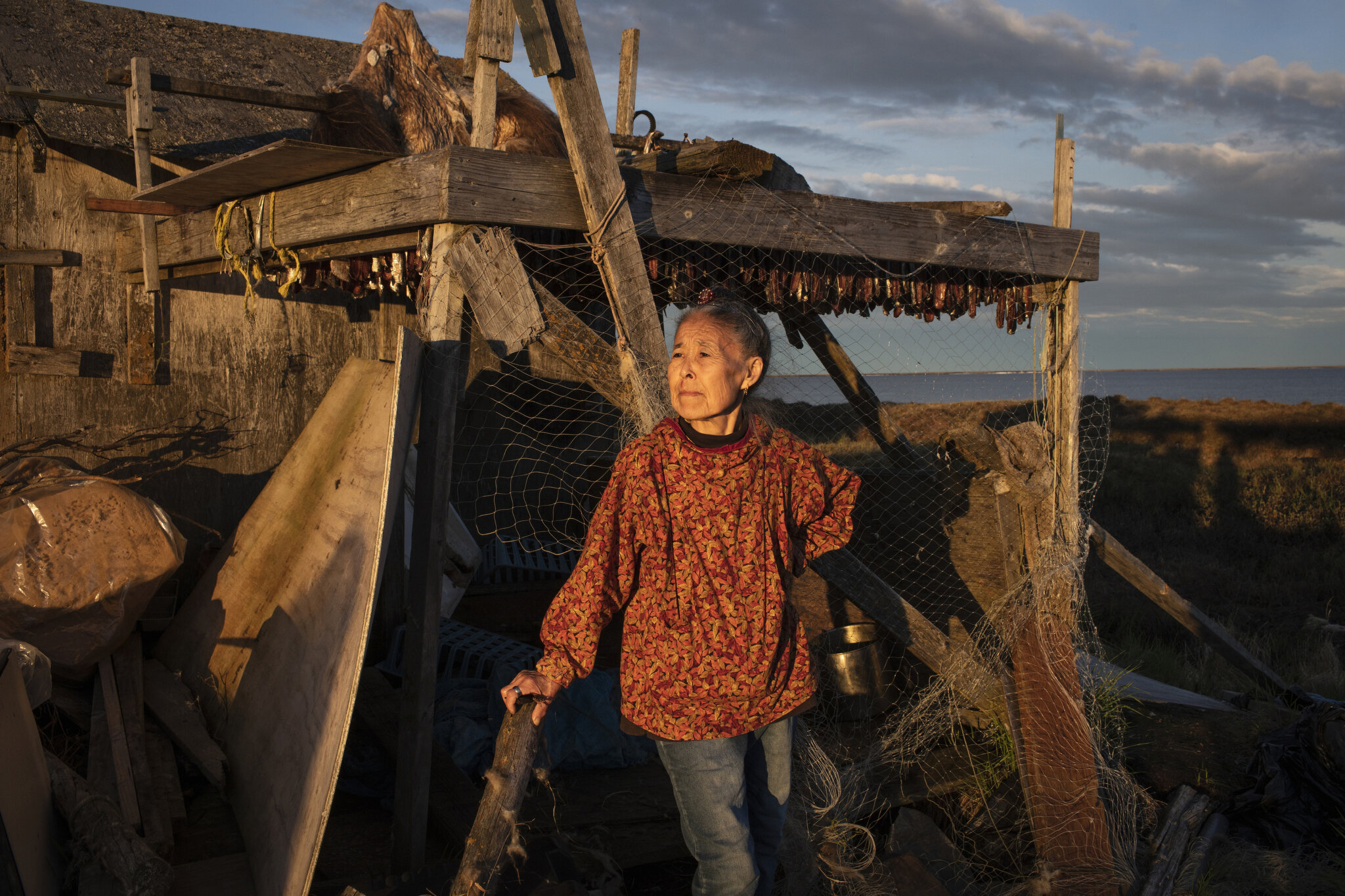  Monica Kasayuli dries herring in a shed outside her then-home in Newtok, Alaska. At the time, Monica's home had been deemed unsafe and she was packing up her family to move to temporary FEMA housing. Currently Monica and her children have left Newto