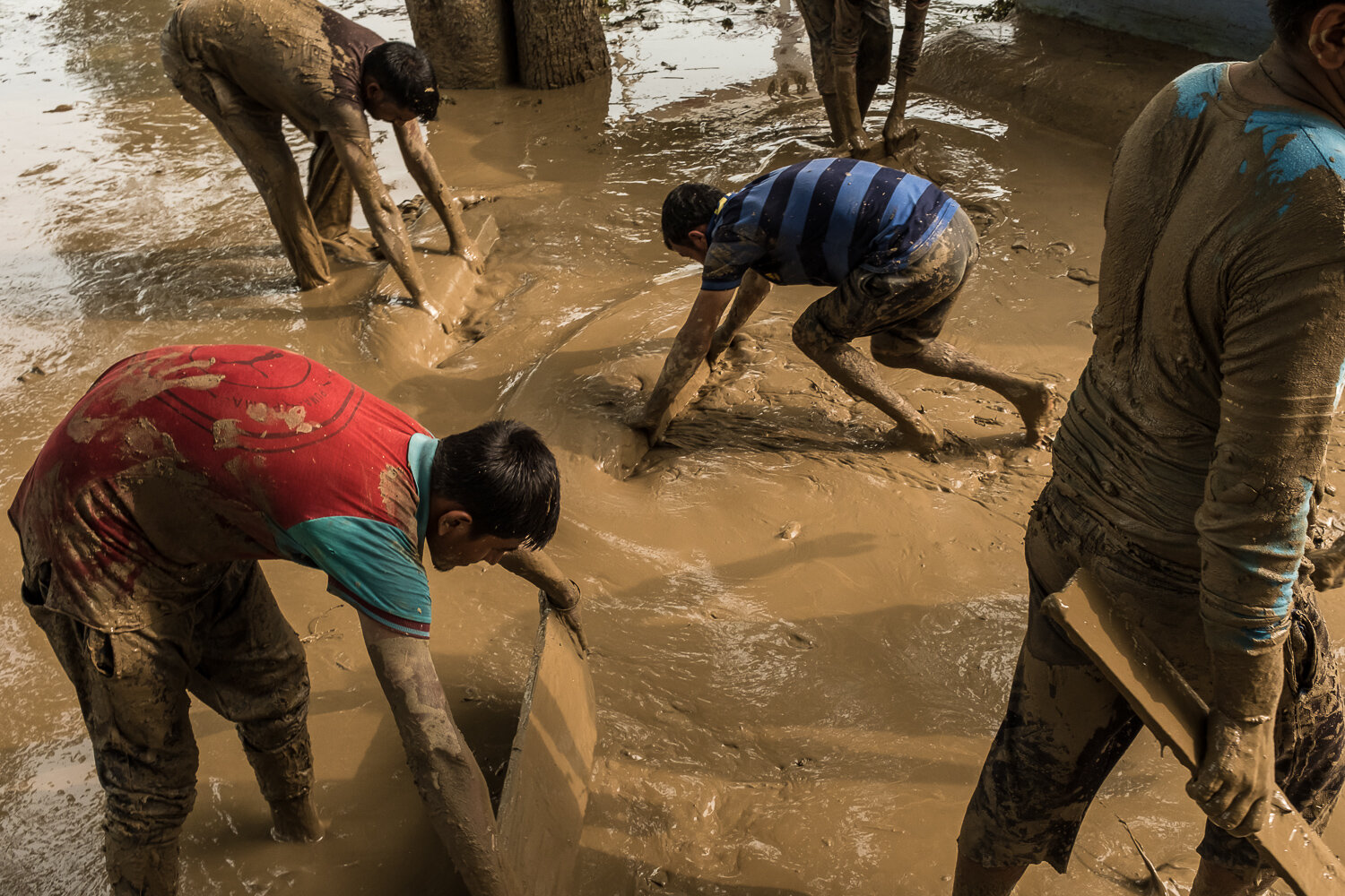  Men clean their local Hindu temple after the canal slicing through town flooded at around 7am that morning on Tuesday, August 8, 2017 in Nai Basti, Jammu & Kashmir, India. Many of the 150 houses in the village were damaged by flooding. 