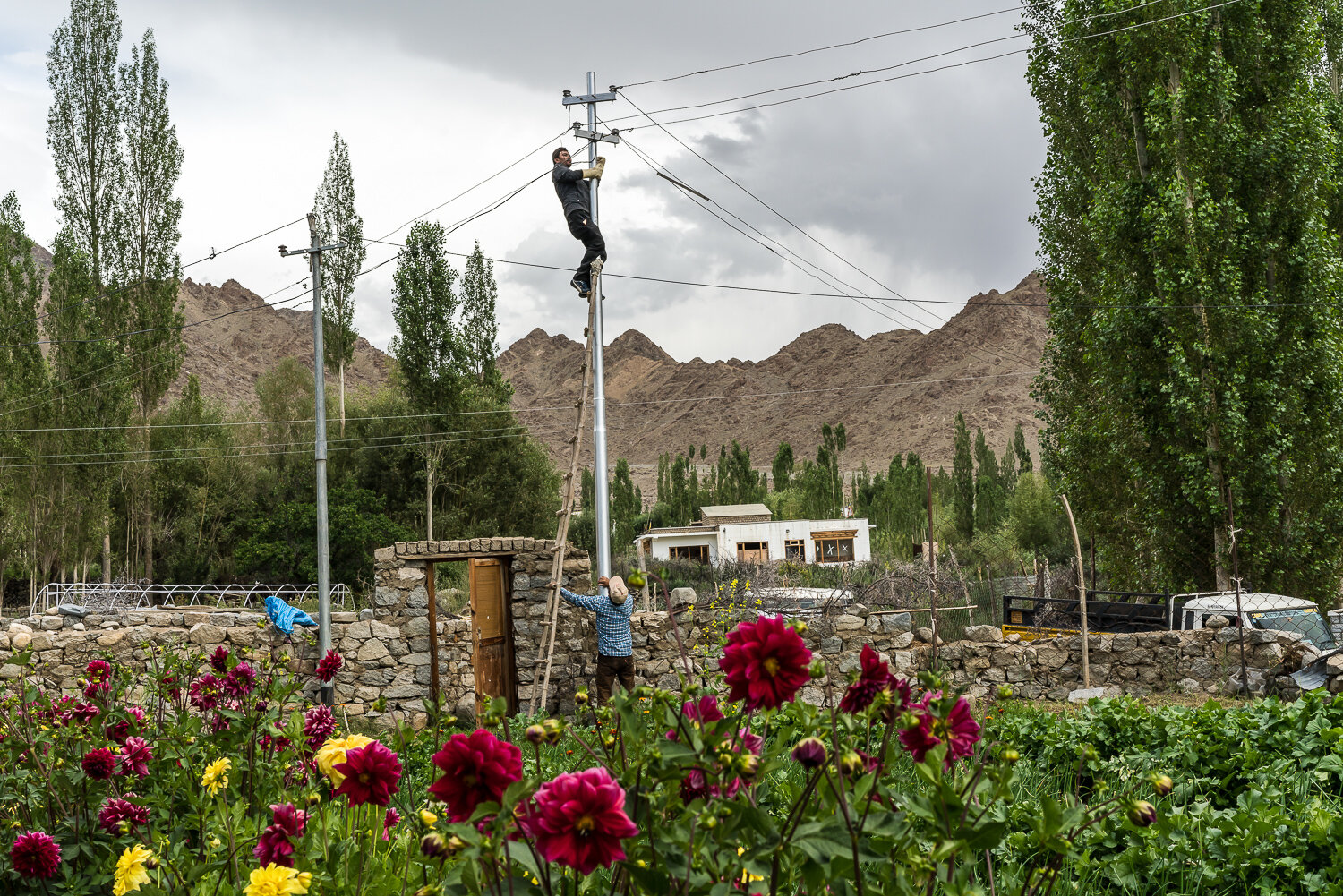  Tashi Motup, on the ladder, and Jigmat Lundup, local linemen, connect electric lines to a house on Tuesday, August 13, 2019 in Saboo, Ladakh, India. India has made a concerted effort in recent years to supply electricity to rural villages all over t