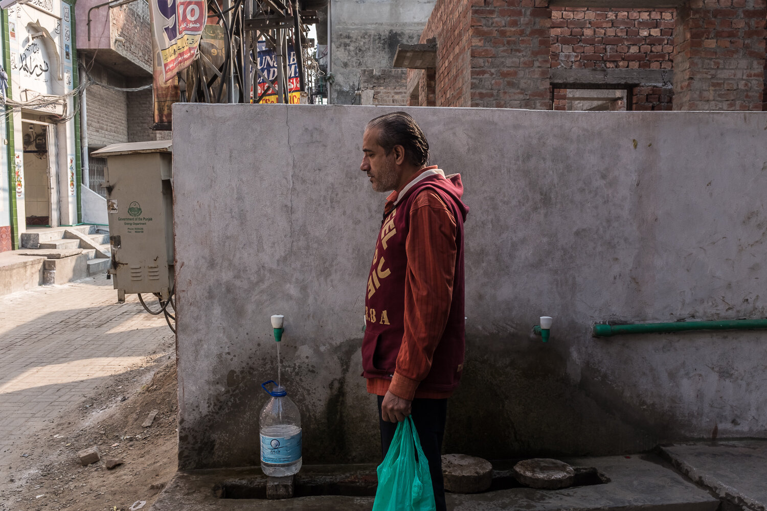  A man fills bottles with water at a community tap on Monday, November 20, 2017 in Lahore, Punjab, Pakistan. Many parts of the city do not have running water in every house, and in those that do the water is unsafe to drink. In 2018 Lahore was forced