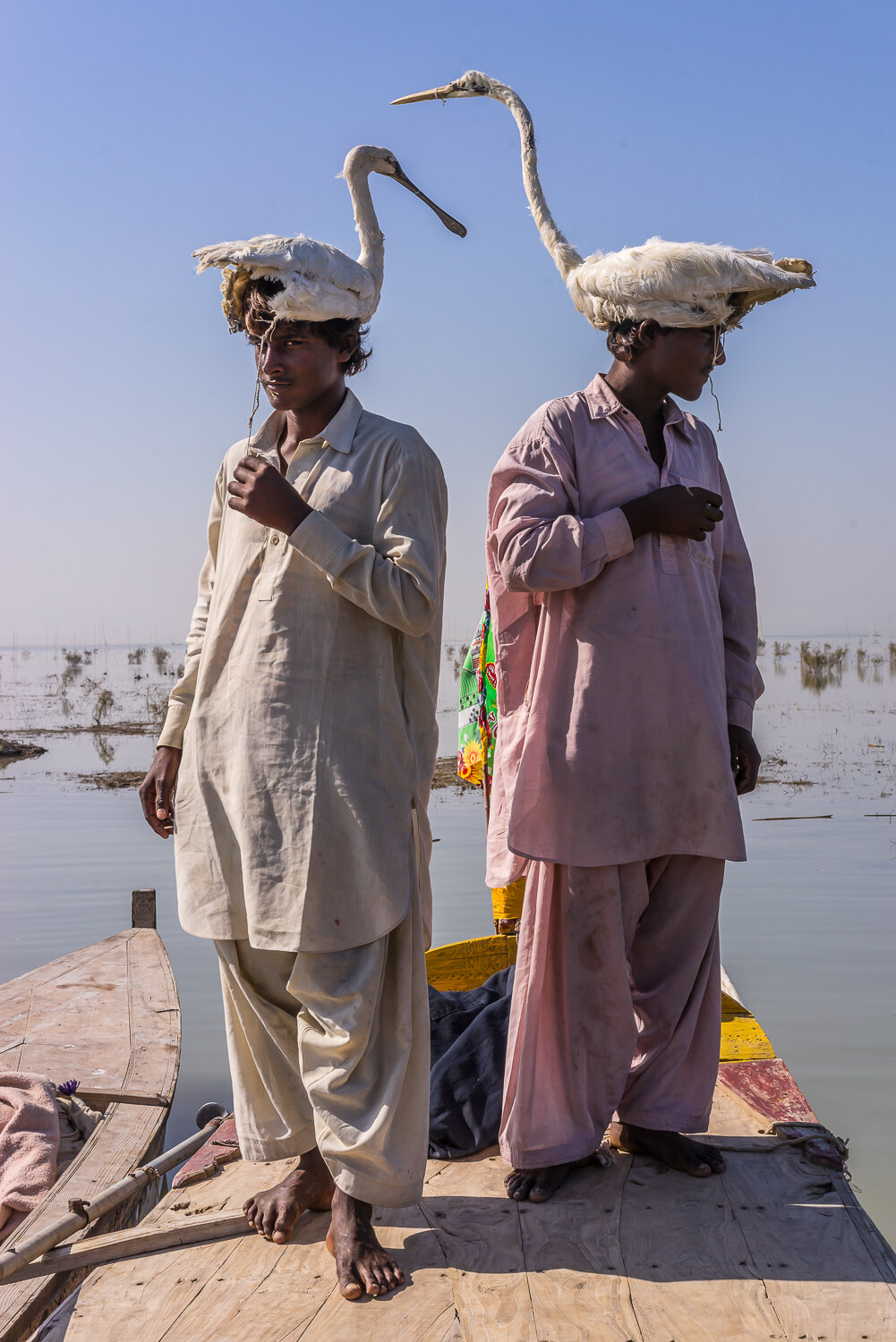  Residents of the floating village on Manchar Lake pose for a portrait with artificial birds, which they use to disguise themselves for bird hunting, on Monday, November 27, 2017 on Manchar Lake, Sindh, Pakistan. Due to the lake becoming more pollute
