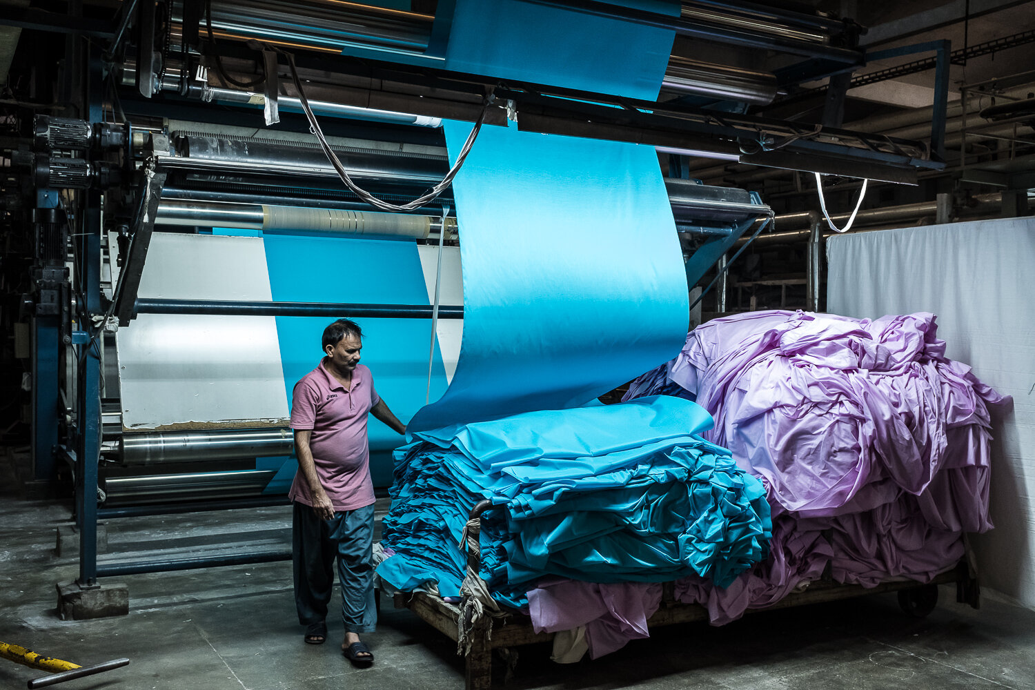  A worker tends to a fabric dyeing machine at MK Sons, a textile factory, on Wednesday, November 22, 2017 near Khurianwala, Punjab, Pakistan. 
