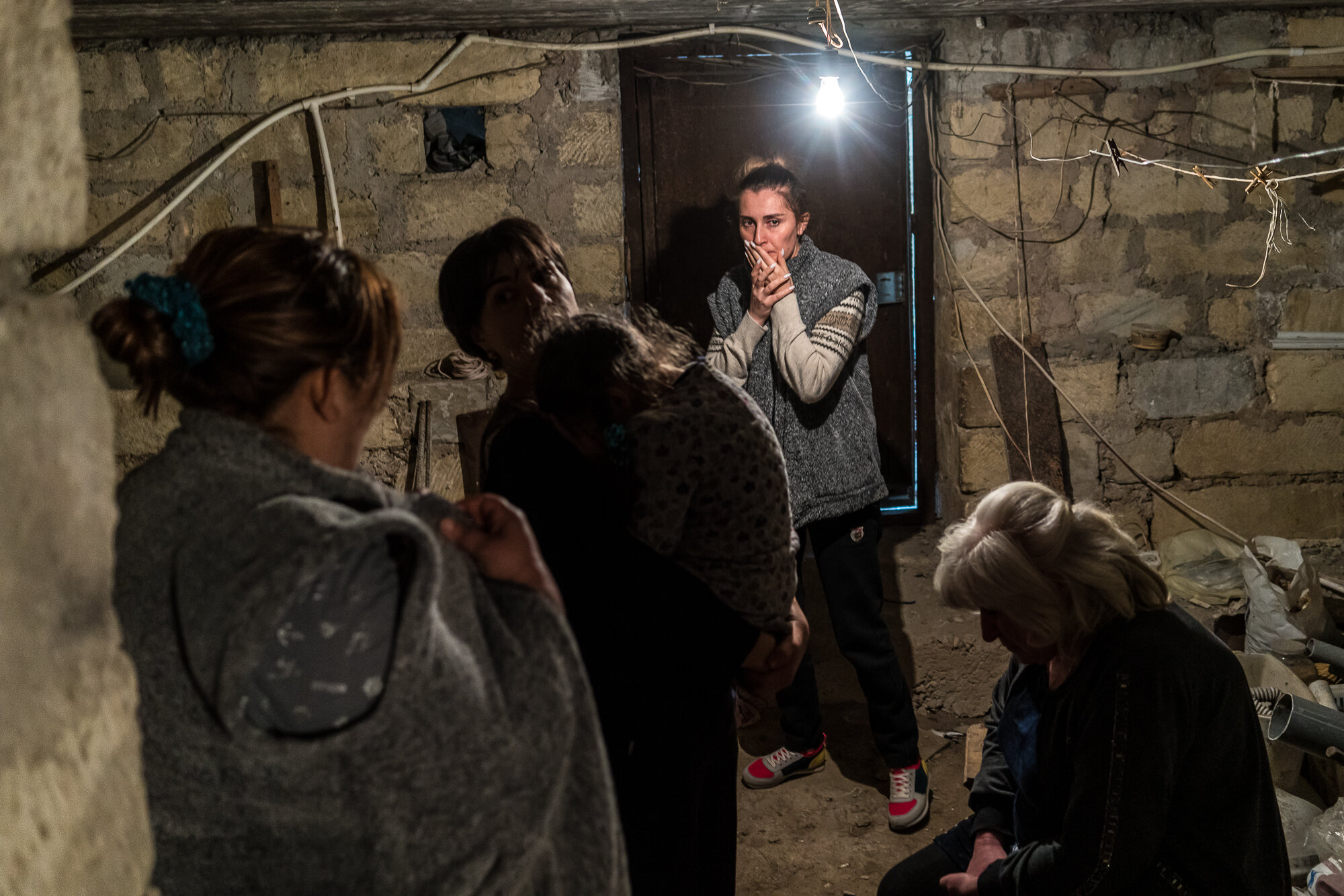  Residents shelter in a basement as air raid sirens sound. Stepanakert, Nagorno-Karabakh. 2020. 