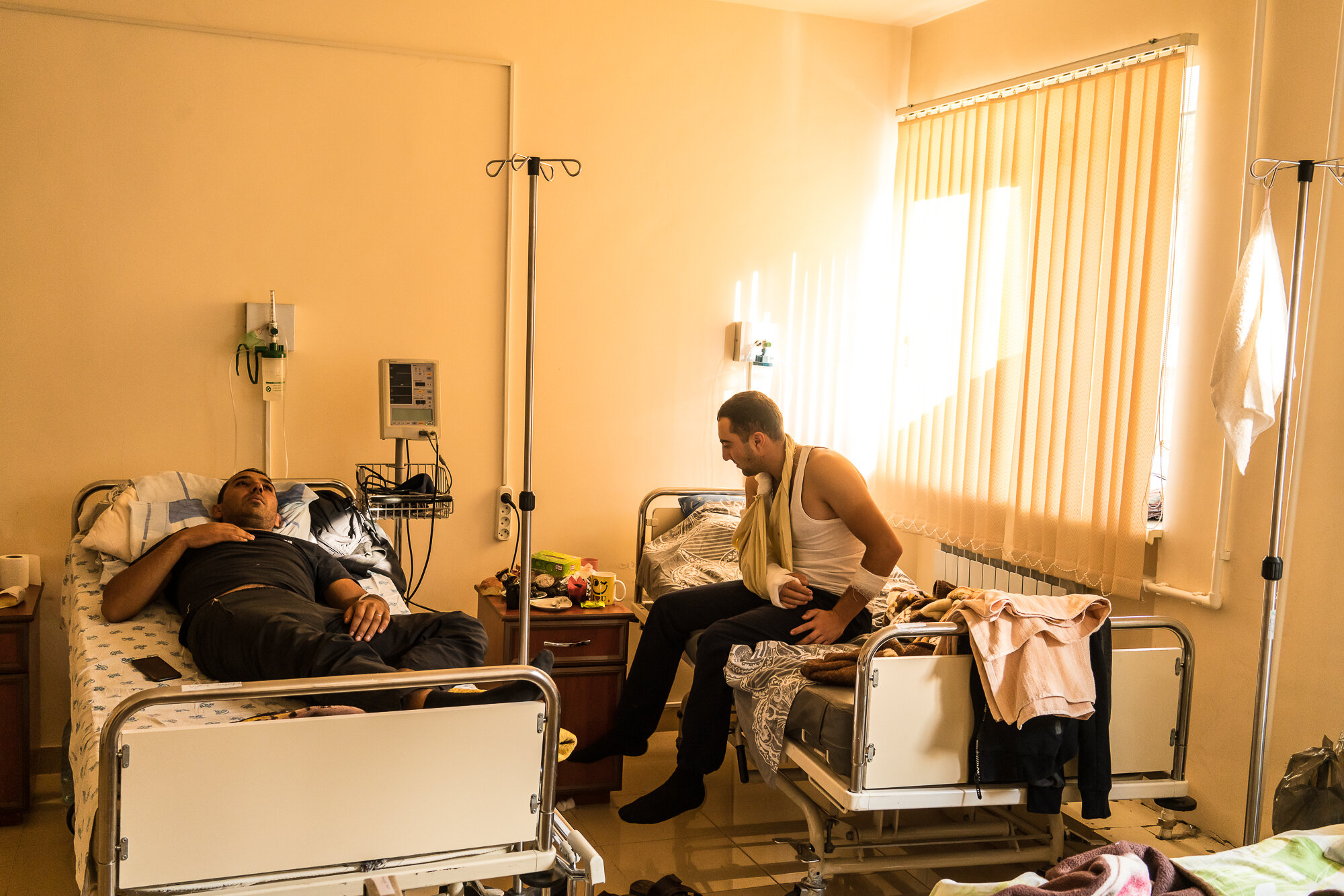  Harut (L), and Sevak (R), both Armenian soldiers who did not want to provide their last names after being wounded in fighting in previous days, sit in their hospital room. Stepanakert, Nagorno-Karabakh. 2020. 