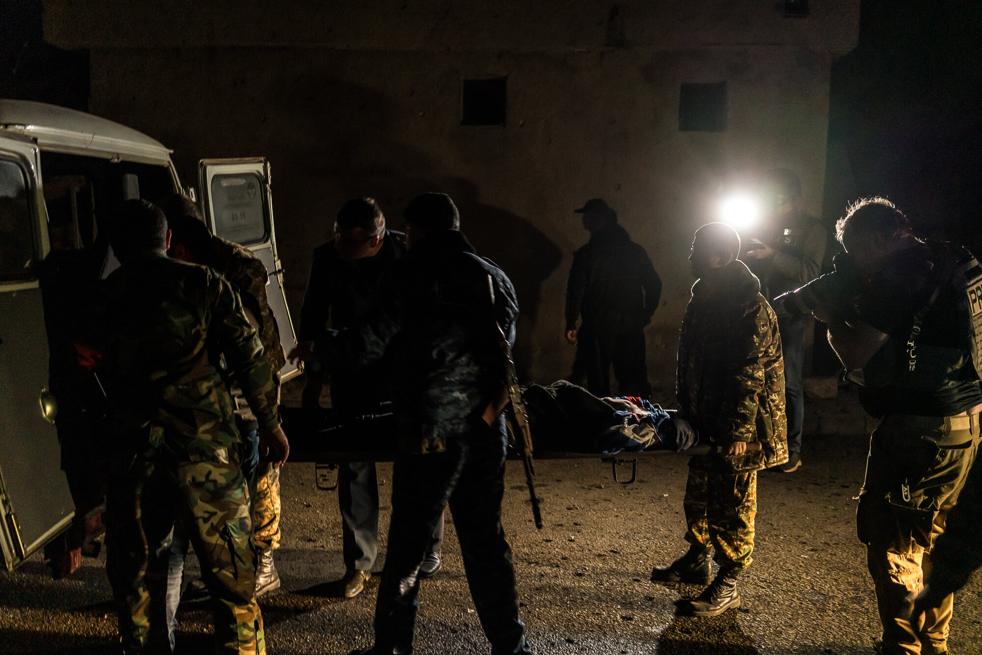  A wounded soldier is loaded into ambulance after an apartment building was shelled. Stepanakert, Nagorno-Karabakh. 2020. 