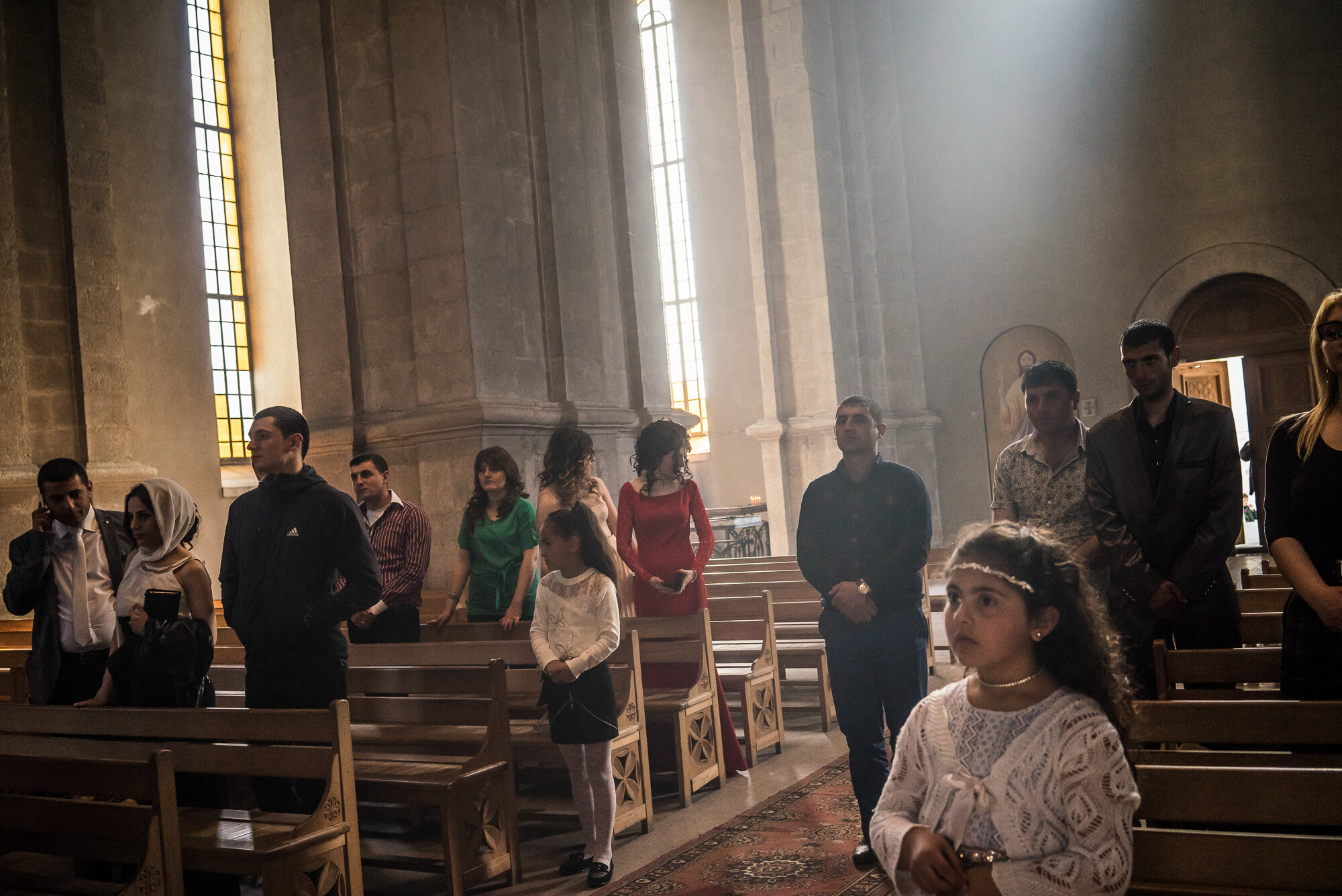  Guests attend the wedding of groom Davit Simonyan, 24, and bride Shogher Hovsepyan, 25, at Ghazanchetsots church. Shushi, Nagorno-Karabakh. 2015. 