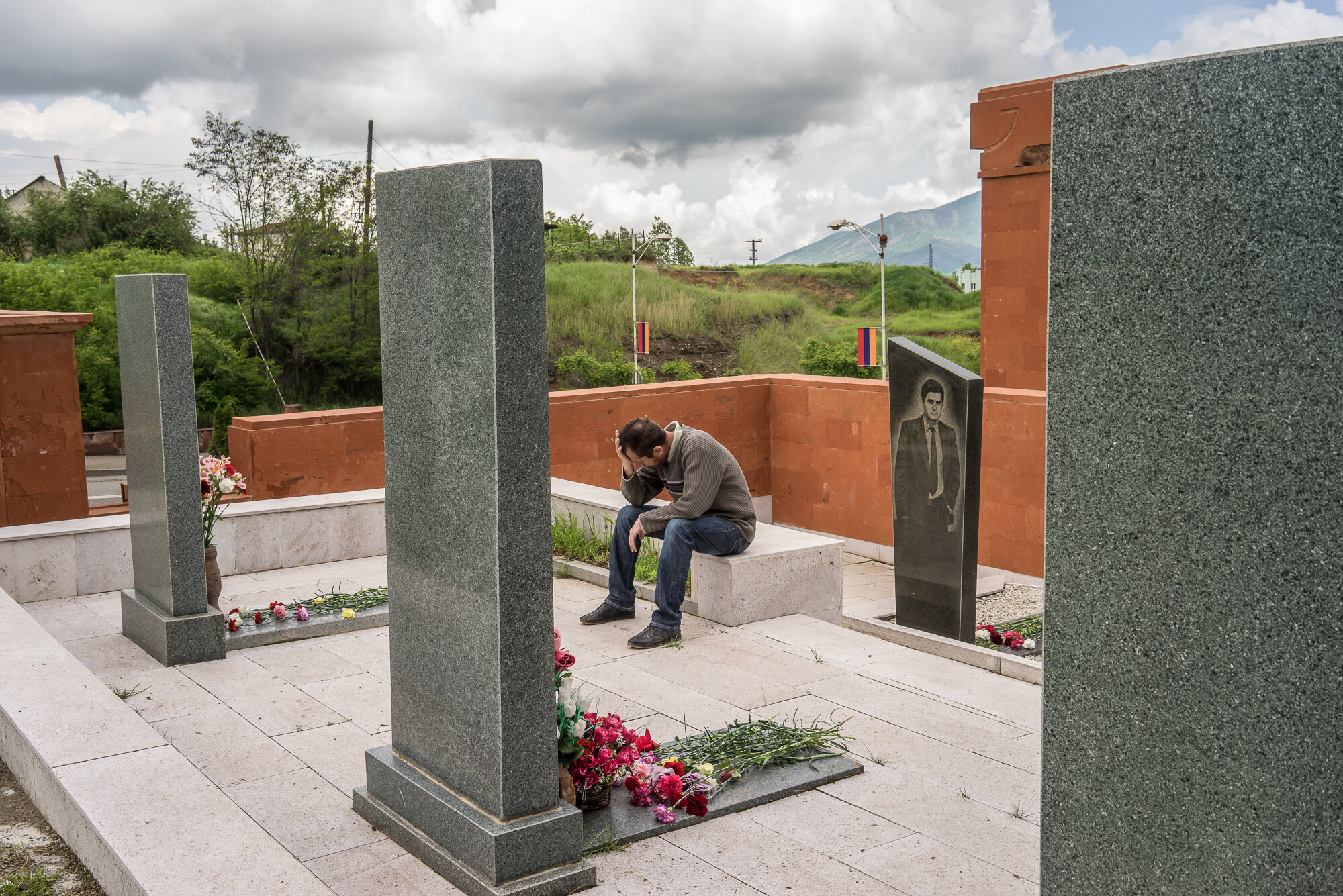  A man cries at the grave of a fighter killed in the 1990s war between Armenia and Azerbaijan following a ceremony commemorating both the victory over Nazi Germany in the Second World War as well as the fall of the strategic town of Shushi to Armenia