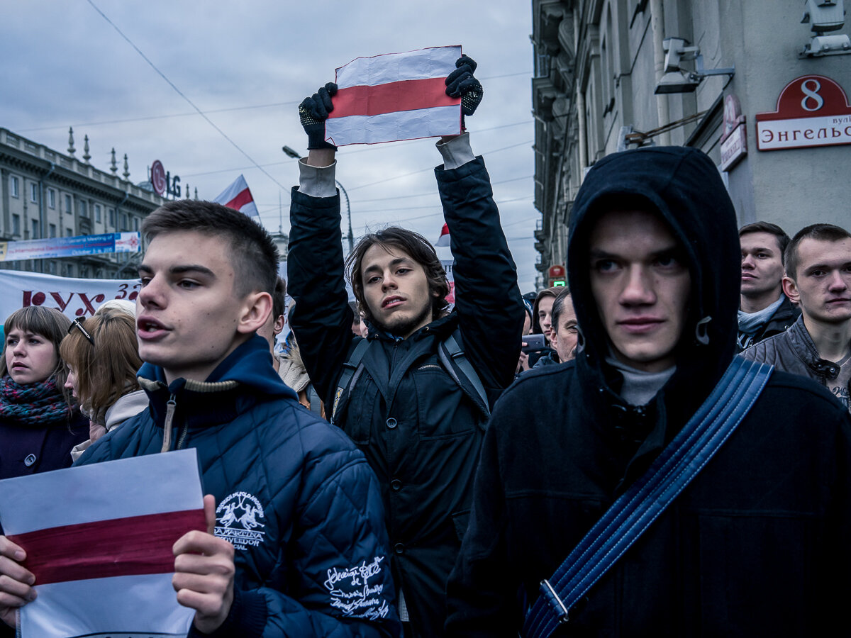  Activists hold Belarusian nationalist flags, a symbol banned as subversive, during an anti-government march on Saturday, October 10, 2015 in Minsk, Belarus. Taking place the day before presidential elections, the march demonstrated a level of freedo