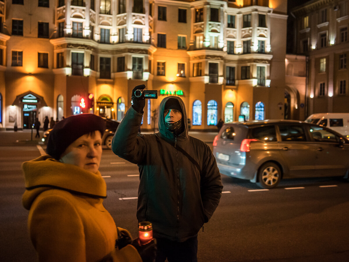  A man believed to be an undercover police officer videotapes a rally organized by Mikalai Statkevich, a former opposition presidential candidate and political dissident, to commemorate the nineteenth anniversary of a referendum which enshrined autho