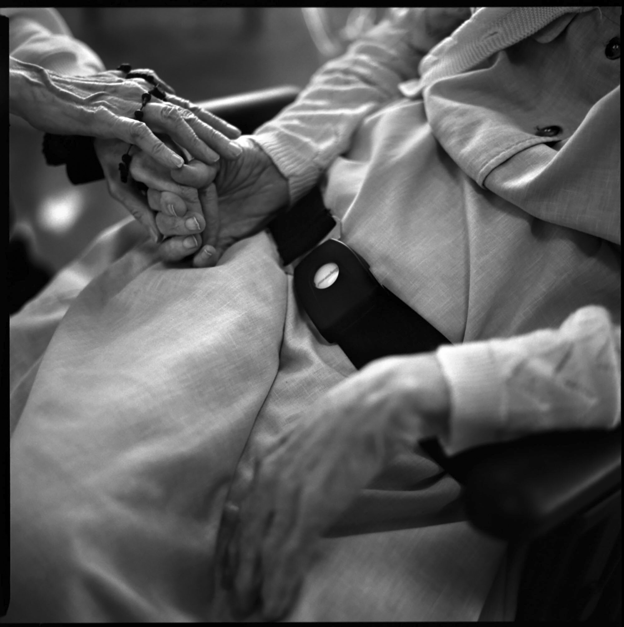  Sr. Noel Devine massages the hands of an elderly Sister with dementia to making her feel comfortable.  