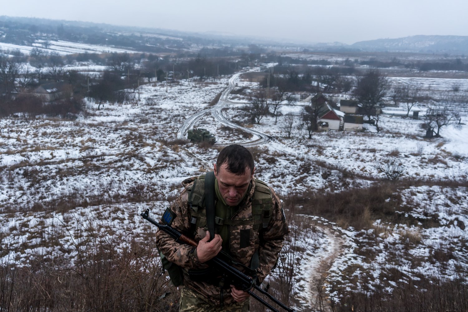  Eduard, a Ukrainian soldier with the 53rd Mechanized Brigade, walks to at a front line on a slag heap position on Wednesday, February 2, 2022 in Novotroitske, Ukraine. 