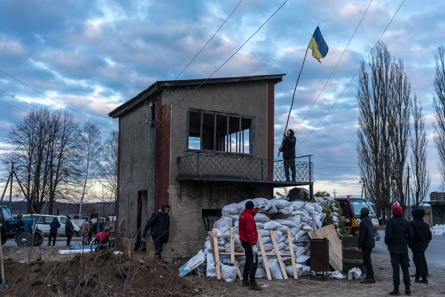  The Ukrainian flag is raised over a newly established checkpoint at the edge of a village on Sunday, February 27, 2022 in Hushchyntsi, Ukraine. 