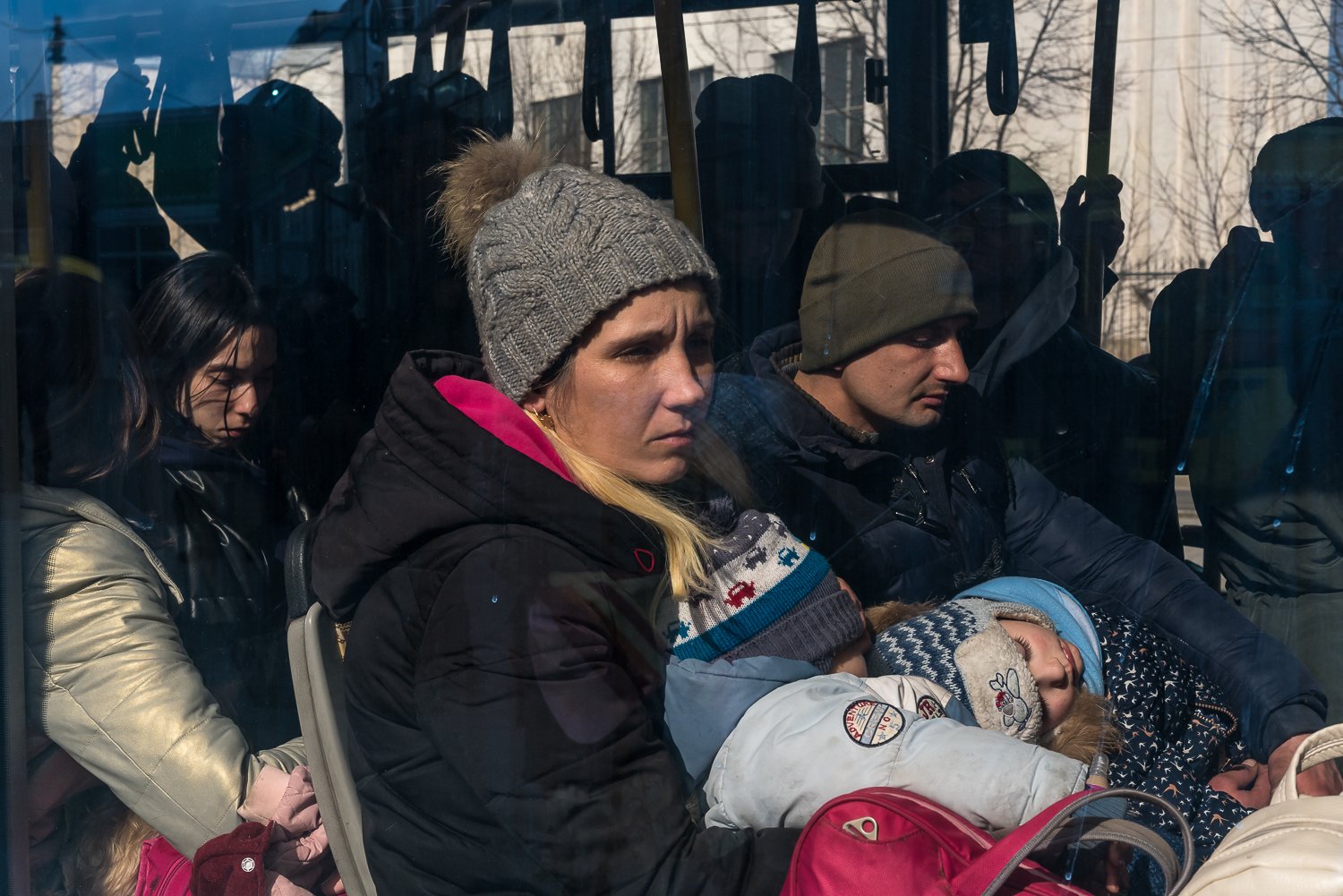  People sit on a bus leaving Ukraine for Poland from the central railway station on Thursday, March 10, 2022 in Lviv, Ukraine. 