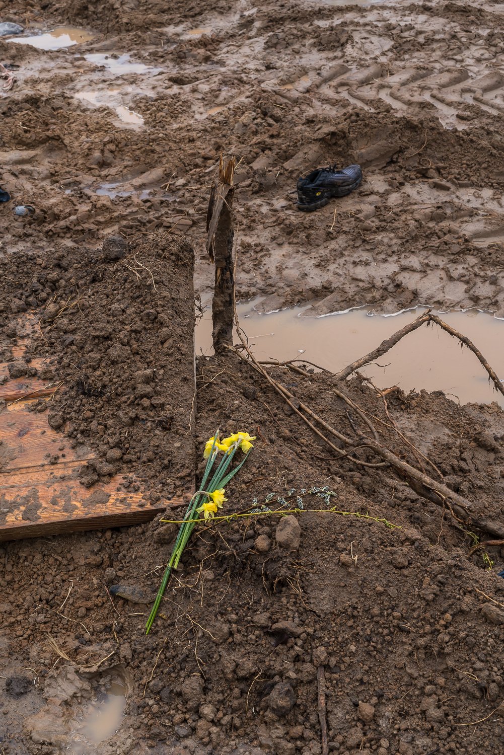  Flowers are left at the site of a former mass grave discovered after Russian troops left the city on Friday, April 22, 2022 in Bucha, Ukraine. 
