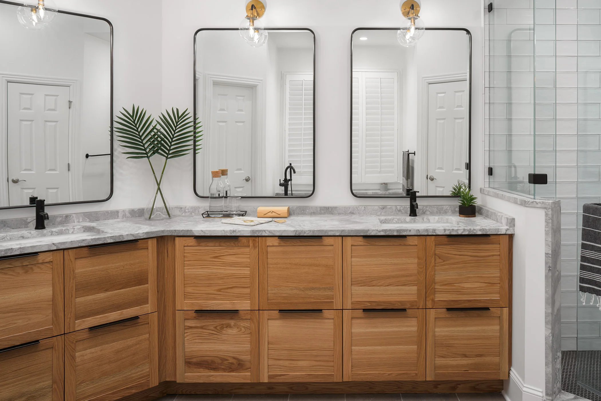 The master bathroom is arguably our favorite transformation of the whole project. Custom white oak cabinets with a honed marble top provide the perfect place to start and end everyday.