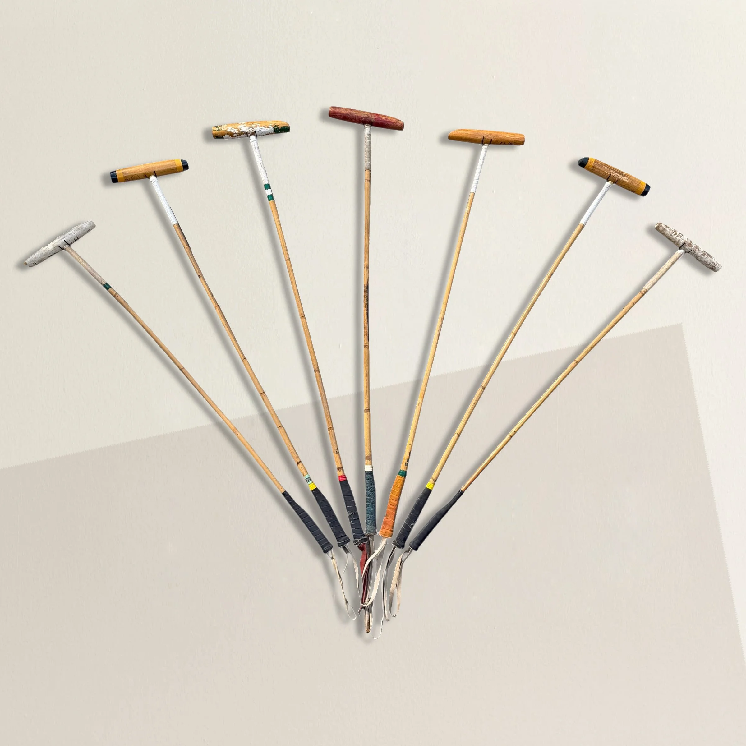 Collection of Seven Vintage Polo Sticks on Custom Wall Mounts