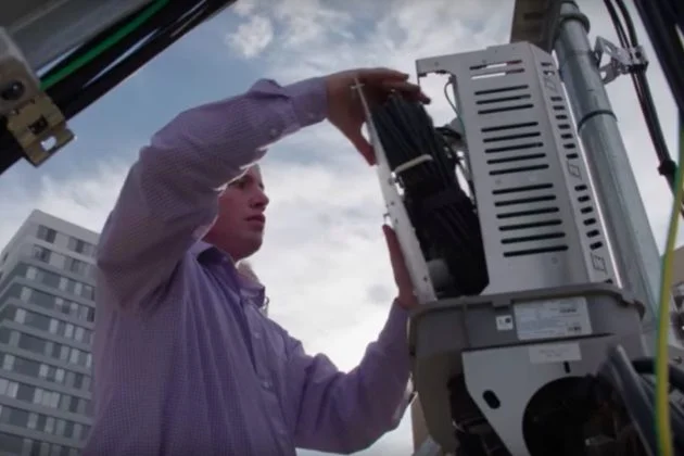 Source: arlnow.com , Verizon worker installing 5G equipment onto Arlington building