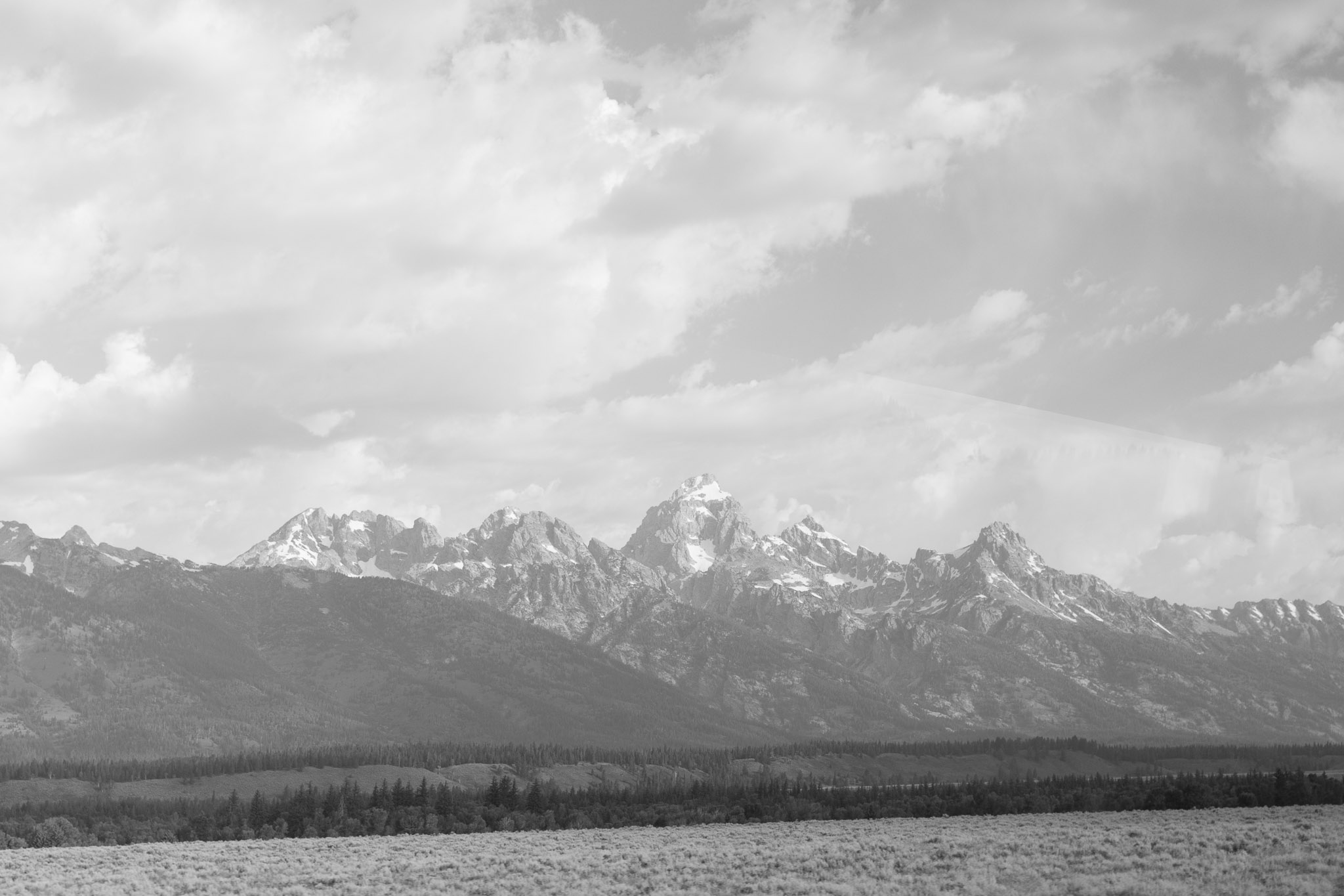 An unprocessed black and white photograph of the Grand Teton Mountains; this was the frame taken just moments before the one turned into 6000 Feet.