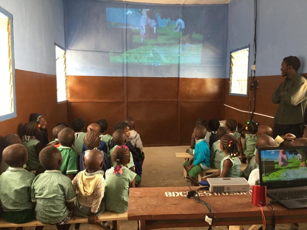 Children singing nursery songs in the library using our projector.