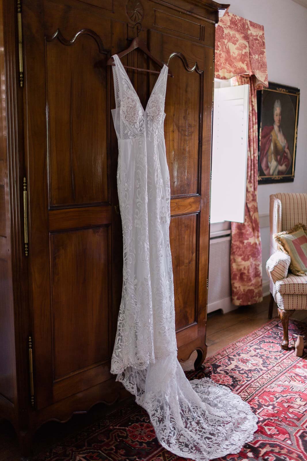 bridal-gown-hanging-on-wooden-bureau-at-1804-inn-at-barboursville-vineyards