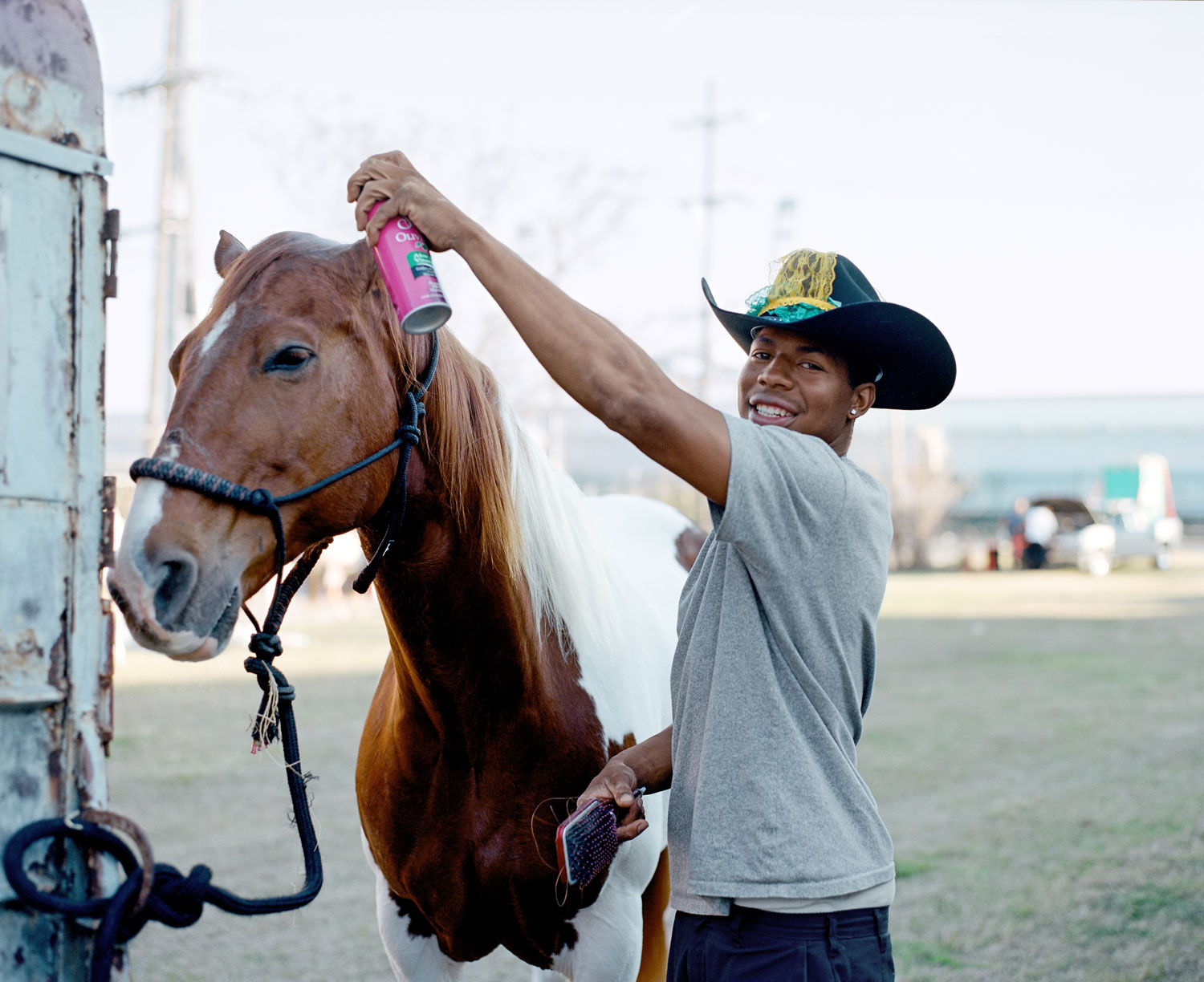 Devence grooms his horse, Cane, before a Mardi Gras parade