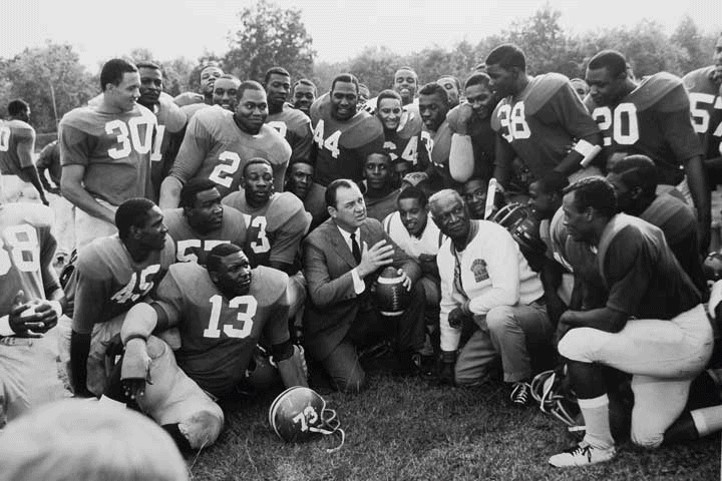 Gaither-kneeling-in-front-of-team.jpg