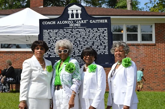 Members of the Ladies Arts and Social Club, who served as hostesses for the installation ceremony, pose in front of the marker. From left: Lenita Joe, Margaree Elkins, Dr. Patty Ball Thomas and Sylvia Petties.