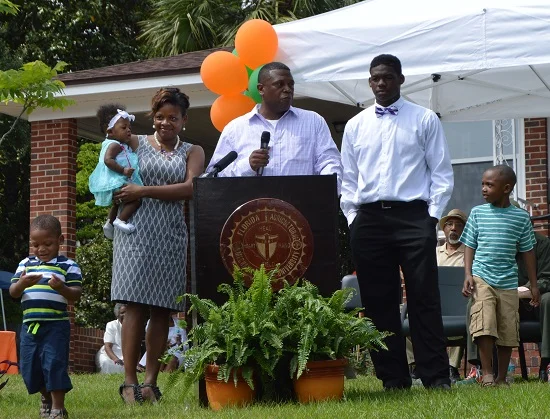 Home owner Cornelius Jones (center) with his family discusses his decision to turn the historic home into a museum. From left: Devin Jones (son), Dalyce Jones (daughter), Reche Jones (wife), Cornelius Jones, Dorrell James (son) and Dorian Jones (son).