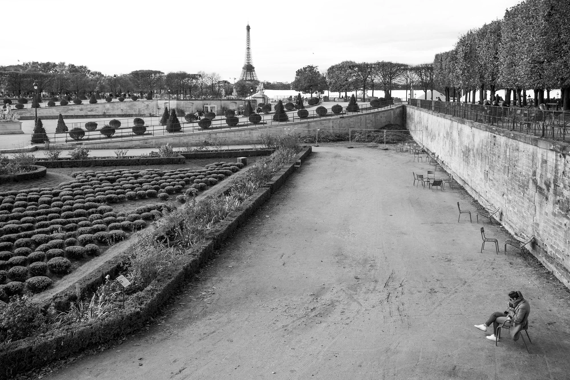 Lady eating lunch alone in the Jardin des Tuileries, Paris, France