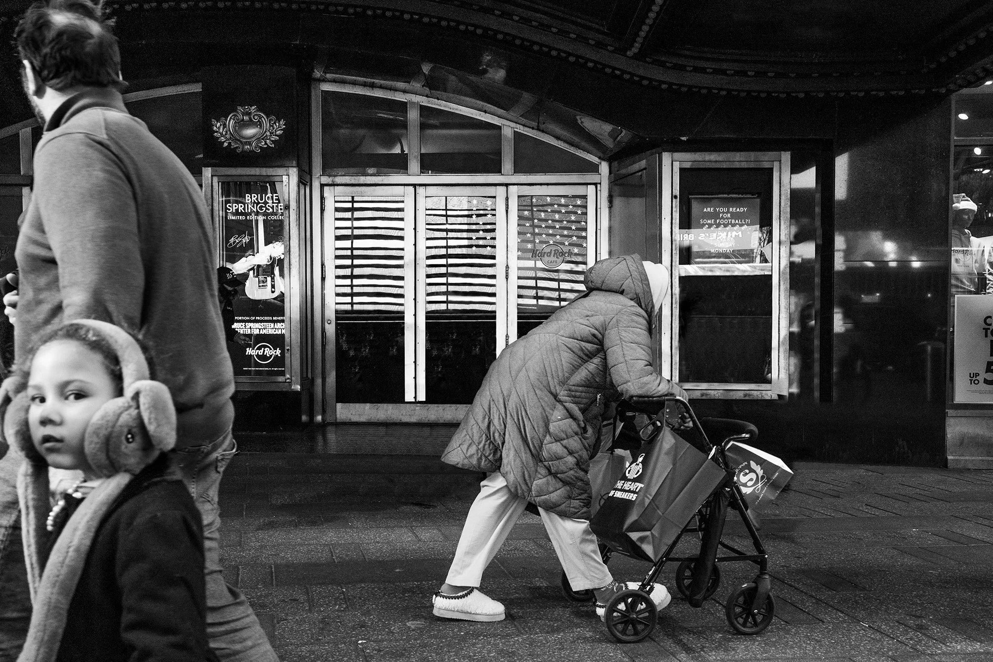 Lady pushing a cart in front of Hard Rock Cafe, New York City, USA